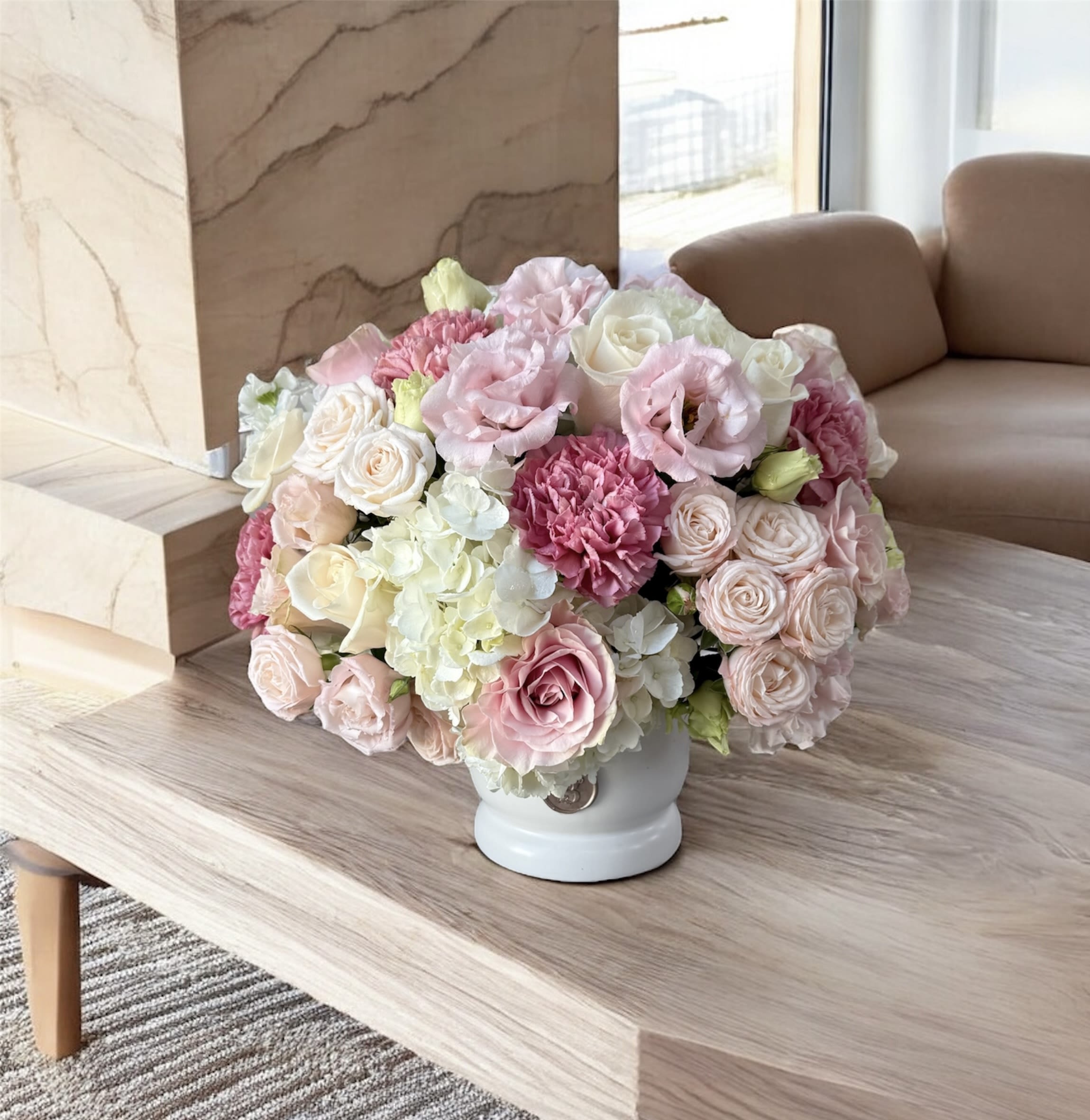 Pink and white rose bouquet in a white vase