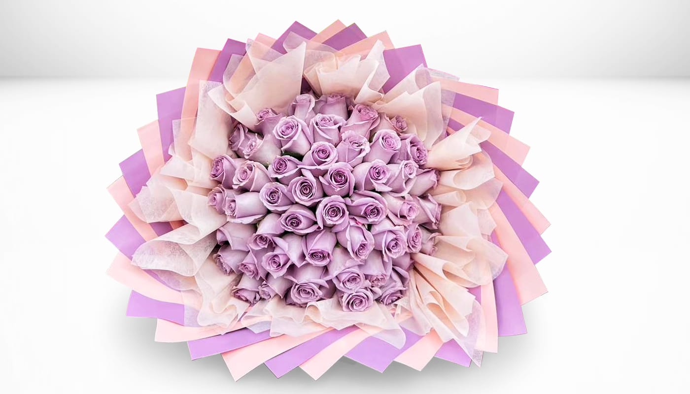 Bouquet of lavender roses wrapped in pink and purple paper