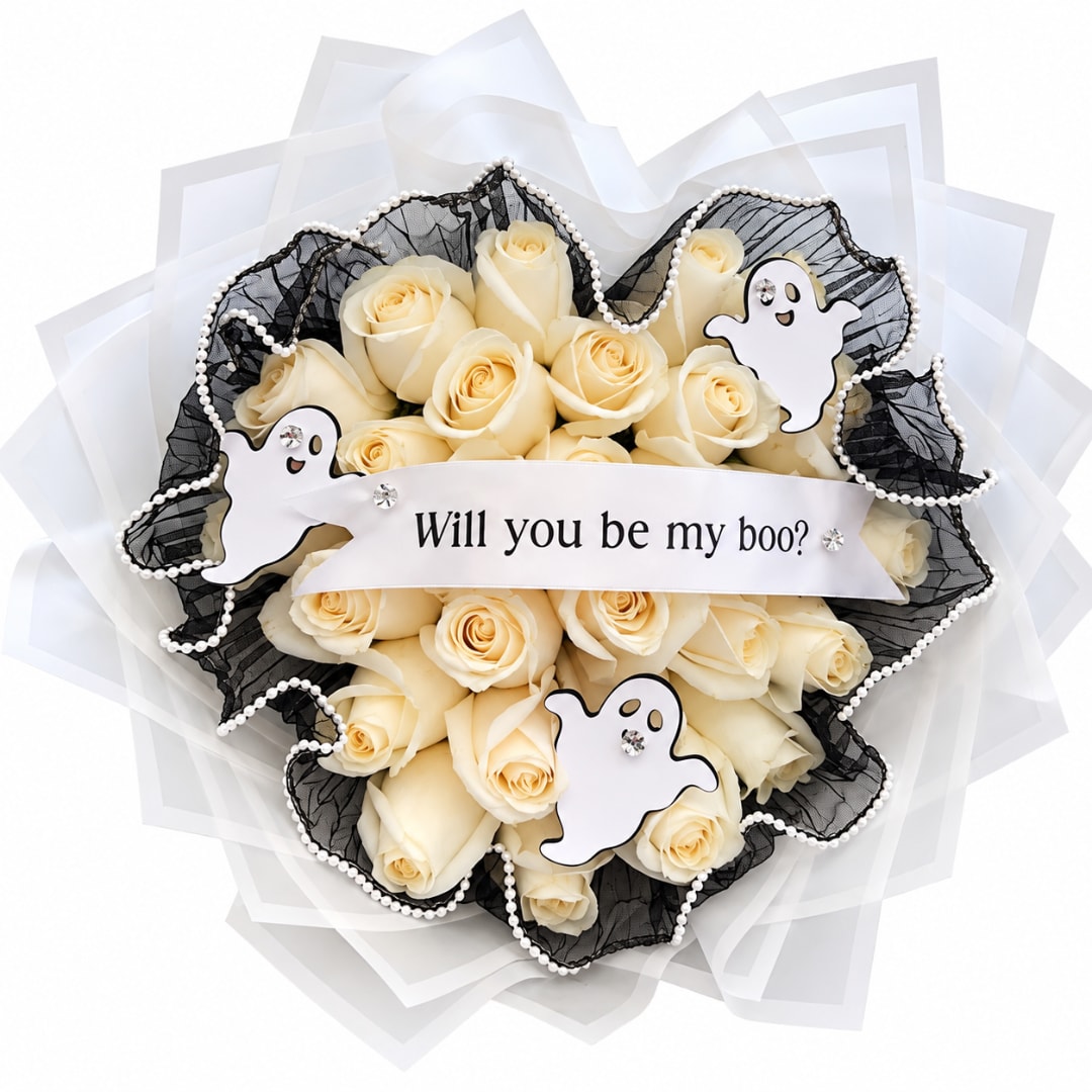 Cream rose bouquet with ghost decorations and a "Will you be my boo?" ribbon