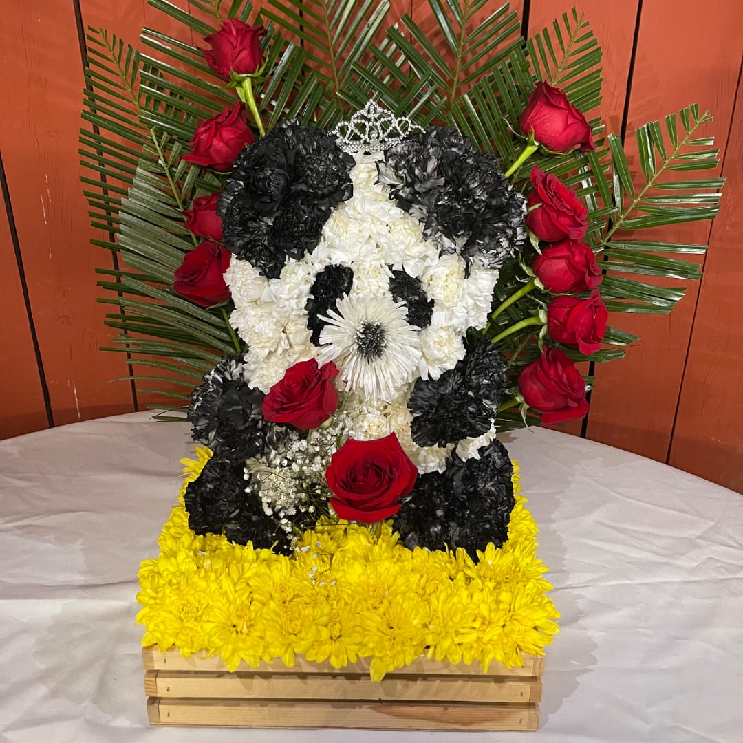 Floral arrangement shaped like a panda face with red roses and yellow flowers