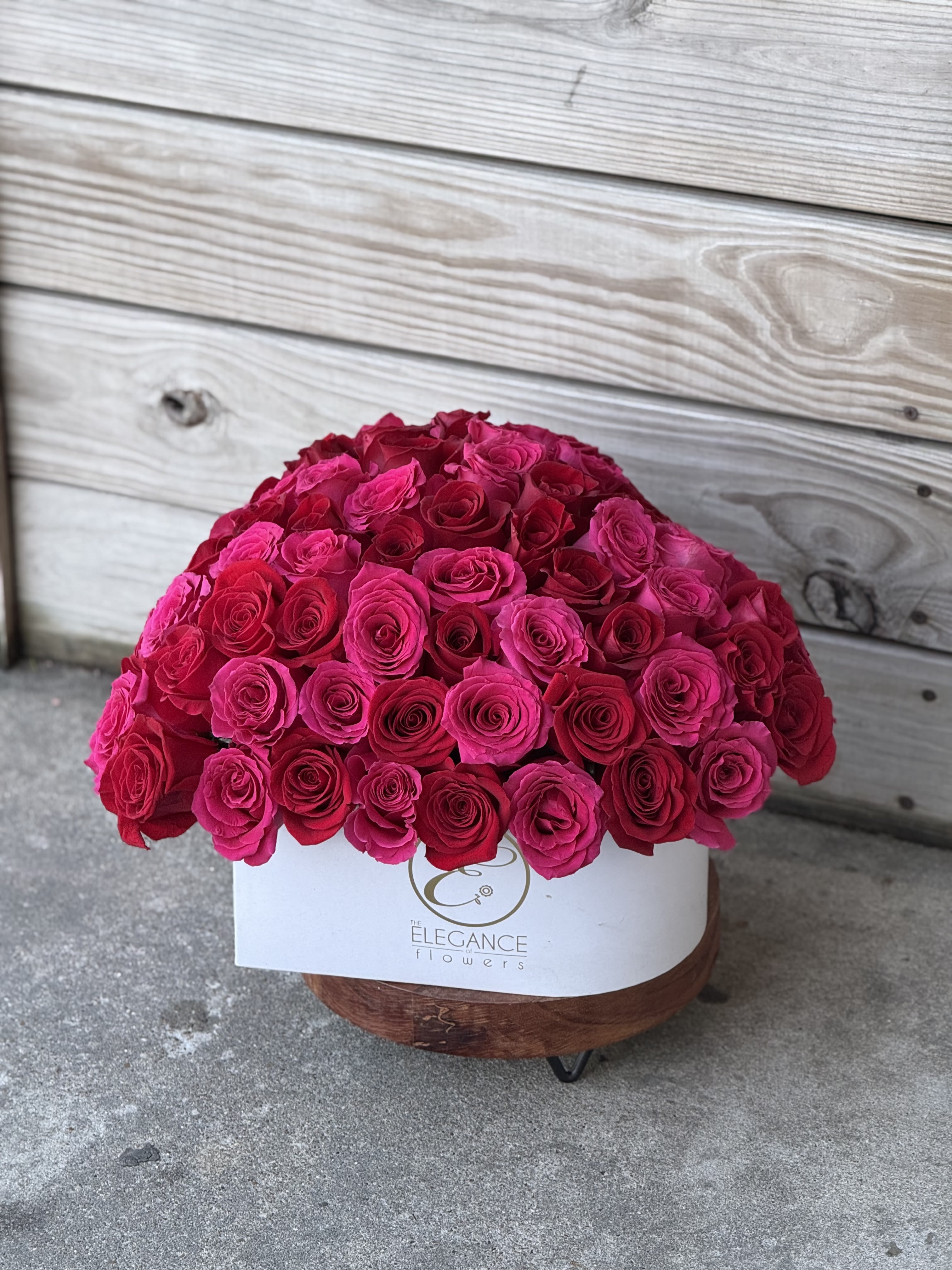 Large dome of hot pink roses in a white box