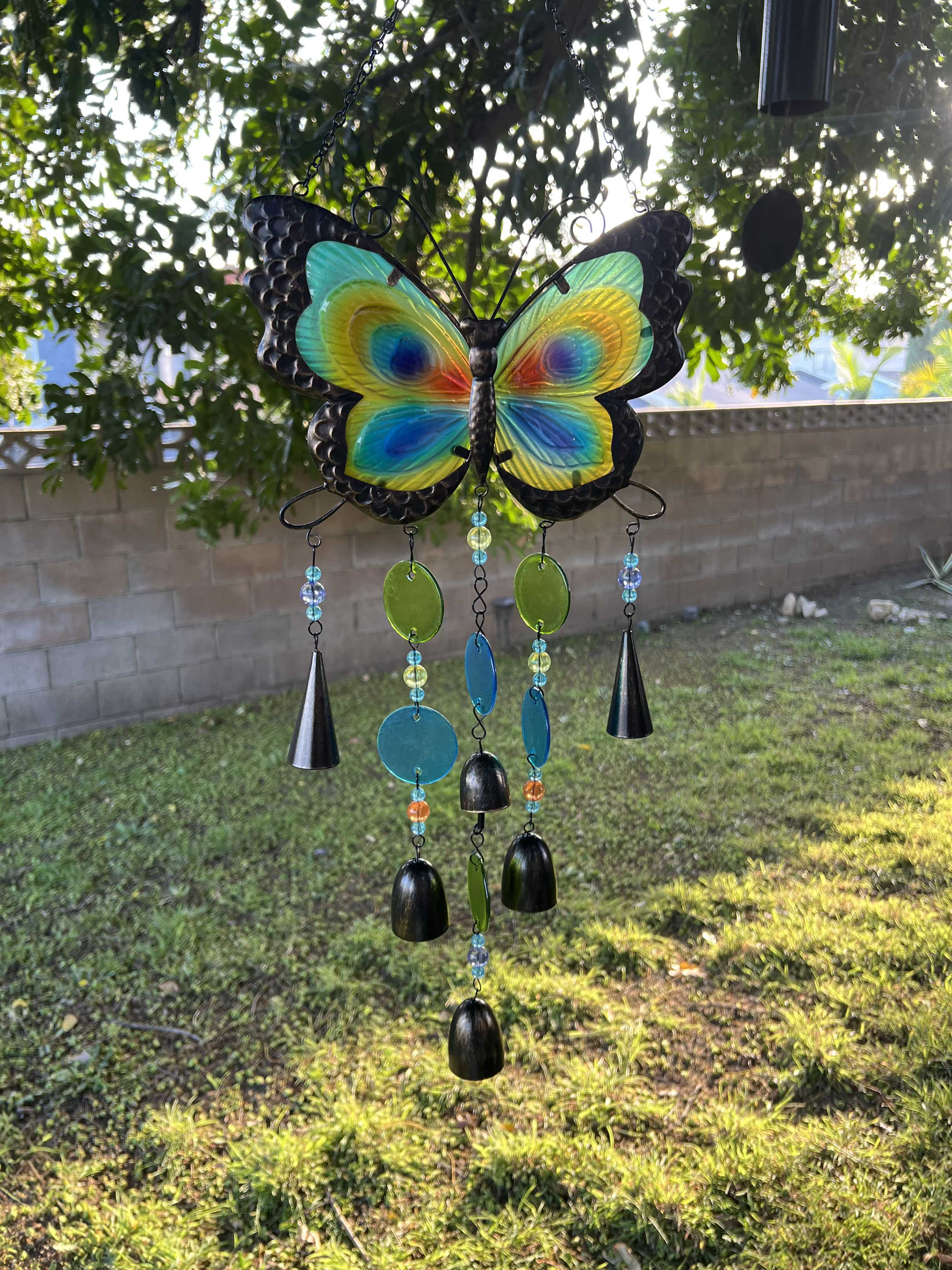 Colorful butterfly wind chime hanging outdoors