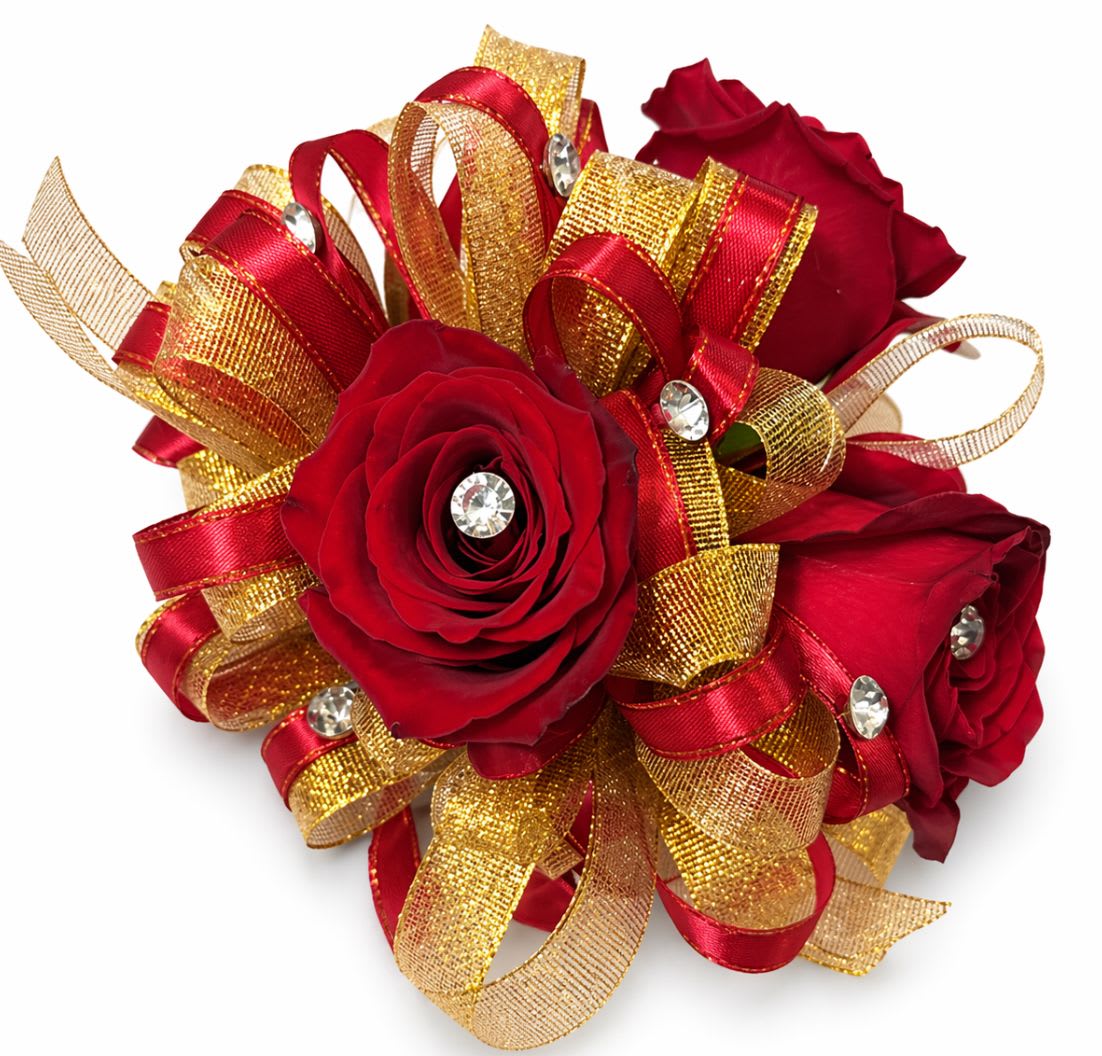 Red Rose Gold Ribbon Wrist Corsage - Saturated red roses form a compact, wearable cluster in this red rose corsage-perfect for prom, a wedding, or a romantic anniversary gift. The dense arrangement sits against looping red and metallic gold ribbon that catches the light, while rhinestone accents add sparkling points of interest so the person you're celebrating will feel polished and noticed.  This wrist corsage comes with coordinating boutonniere details: tightly arranged red roses, layered red-and-gold ribbon trim, and small rhinestone embellishments that create a formal, festive look. The combination of deep red blooms, gold metallic loops, and reflective rhinestones gives a rich contrast between matte petals and bright accents.  Designed to be worn or carried, the small scale makes it ideal for a date night, graduation, bridal party, or any occasion where you want someone to feel celebrated and elegant. Secure with the included pin and enjoy simple care-keep it cool and mist lightly to preserve freshness until the big moment.