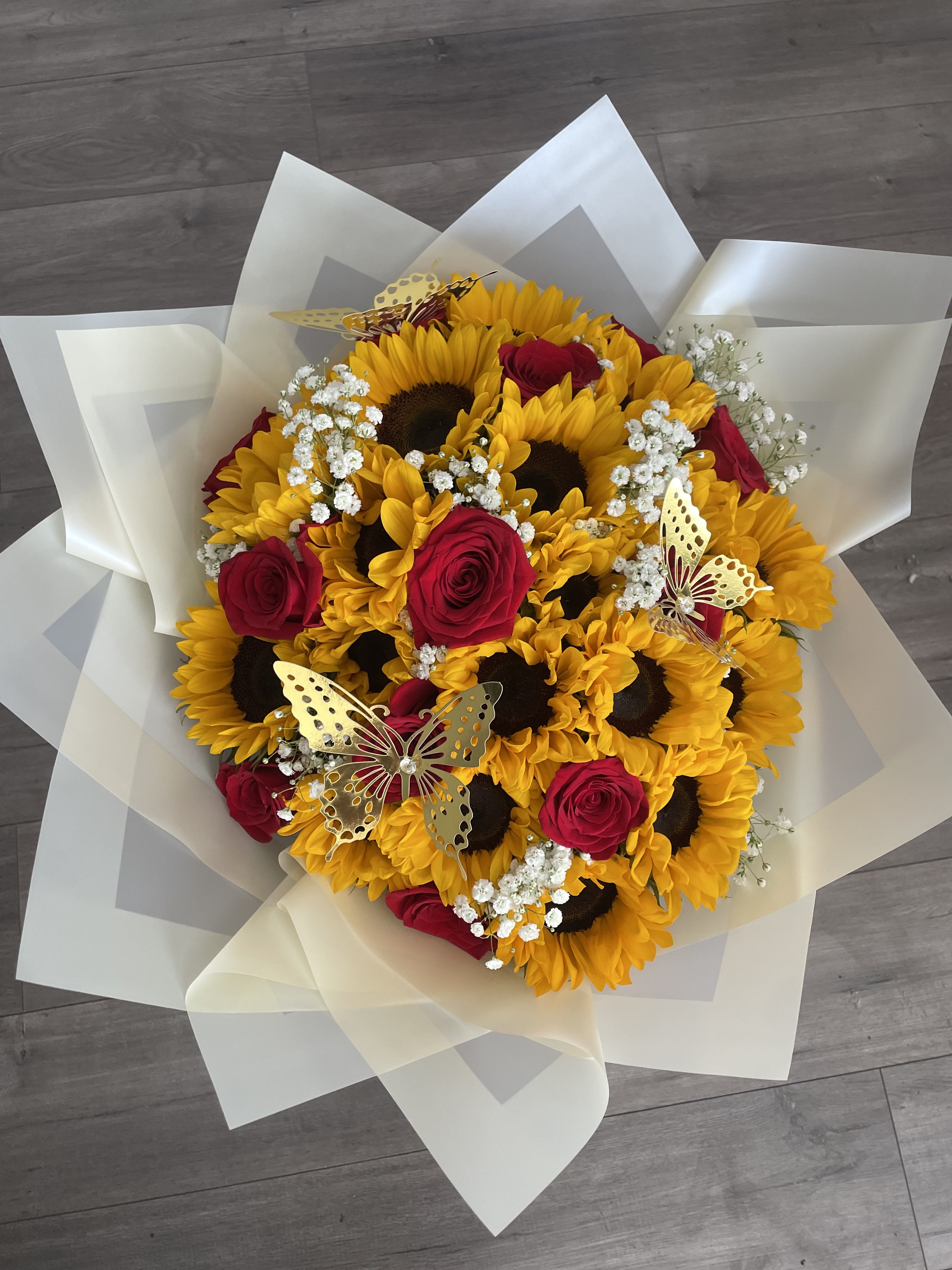 Rose Sunshine Bouquet - 12 Fresh Long Stem Roses and 20 Sunflowers that promise to surprise your loved one.