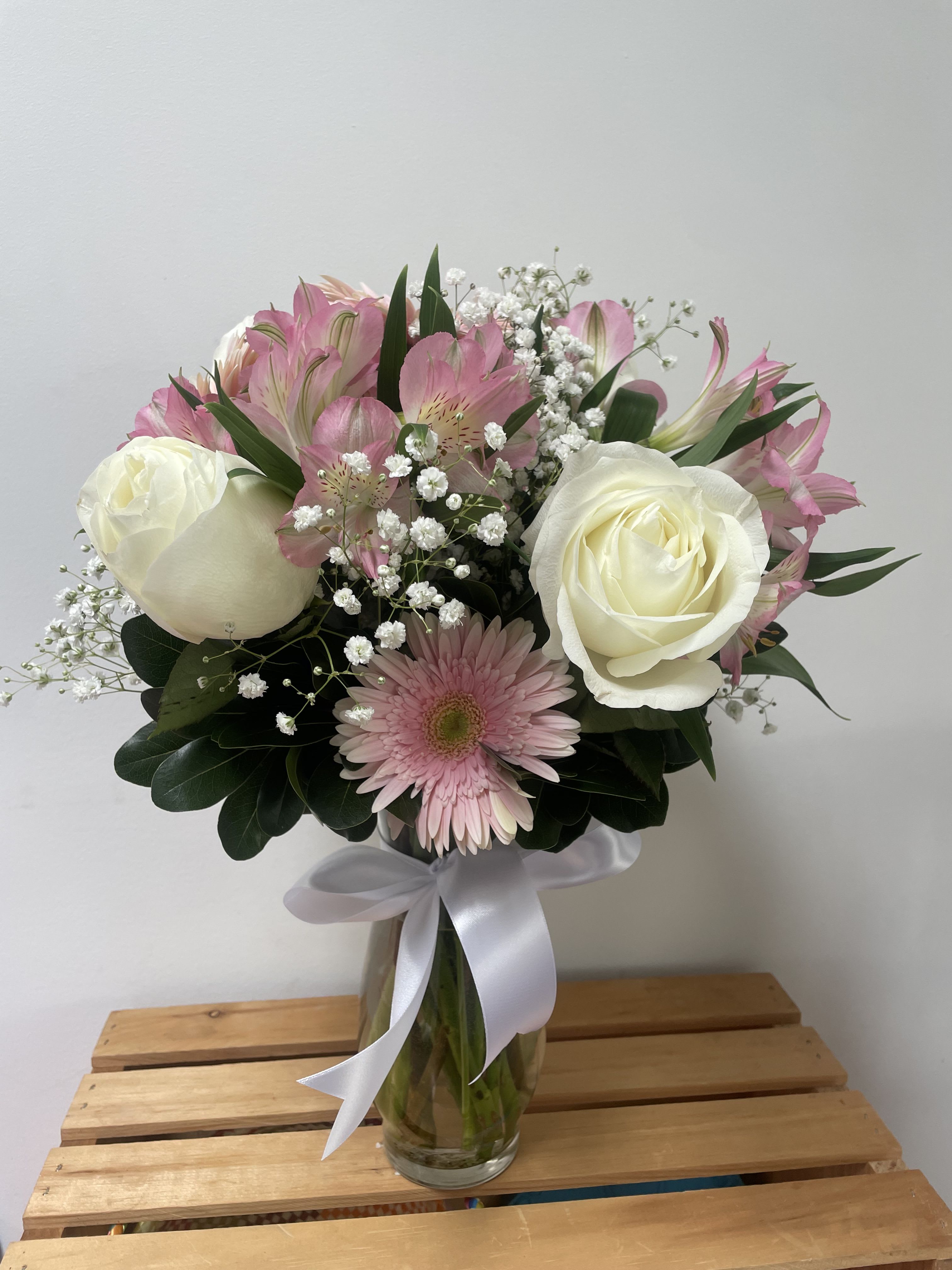Elegant Pink &amp; White Floral  - Brighten any space with this charming bouquet featuring a delicate blend of soft pink and crisp white blooms. This arrangement includes classic white roses, pink gerbera daisies, and alstroemeria, accented with baby's breath and lush greenery. Presented in a clear glass vase and tied with a satin white ribbon, it’s perfect for birthdays, anniversaries, or simply to say "thinking of you."  Freshly arranged by hand, delivered with care.
