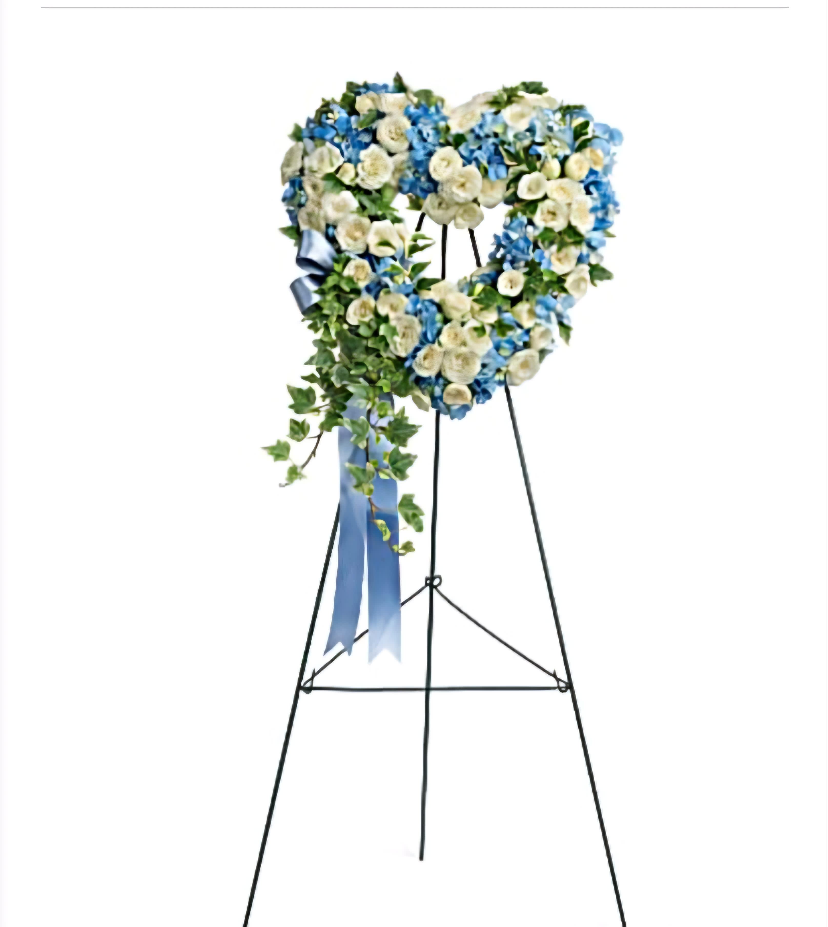 White and Blue Heart-Shaped Funeral Standing Spray - Offer a serene tribute with our White and Blue Heart-Shaped Funeral Standing Spray, meticulously designed with white and blue flowers to symbolize peace, tranquility, and eternal remembrance.      