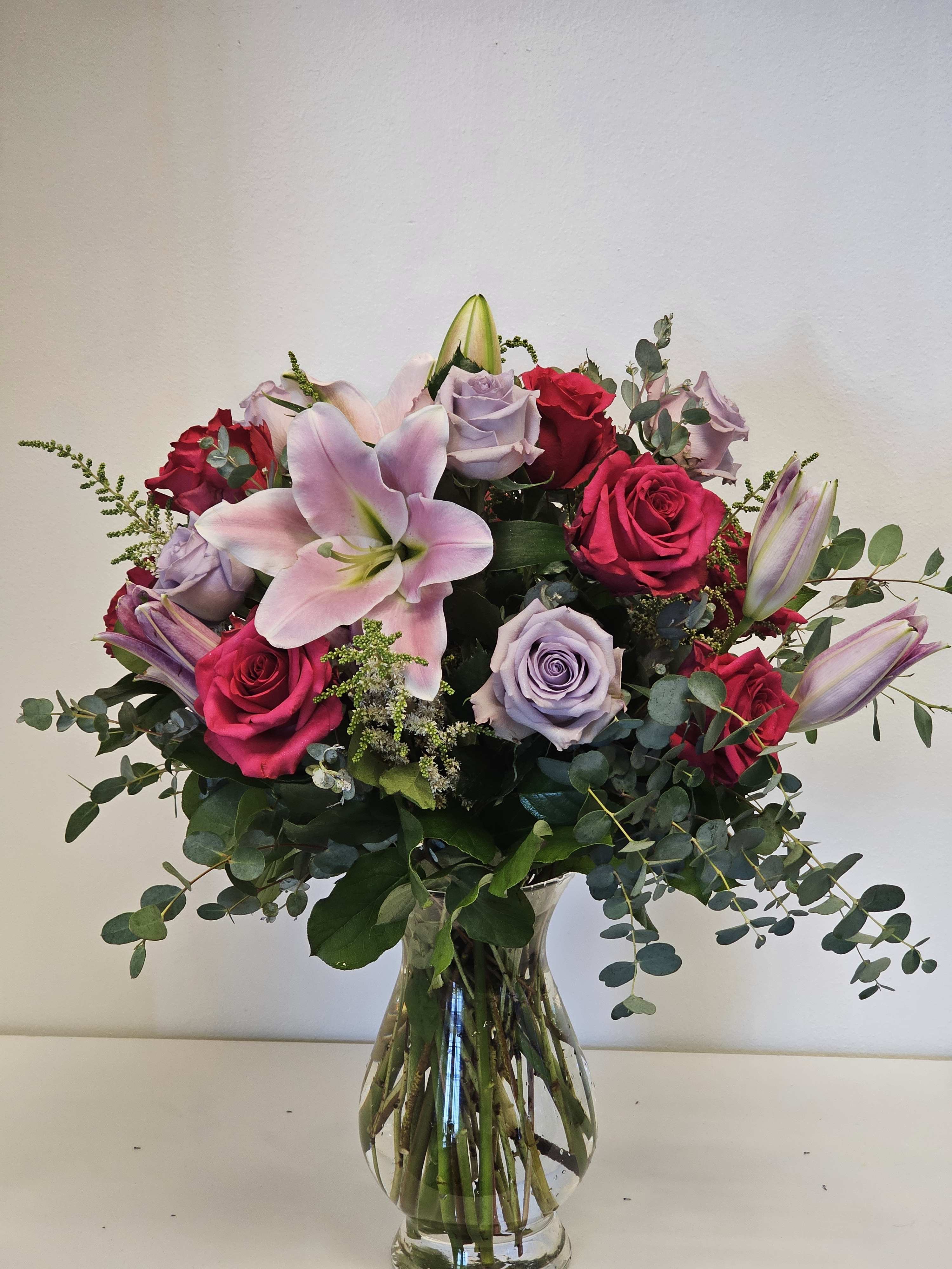 Beautiful flower arrangement purple and pink  - A stunning floral arrangement of purple and pink blooms, gracefully intertwined to create a mesmerizing display of color and elegance.