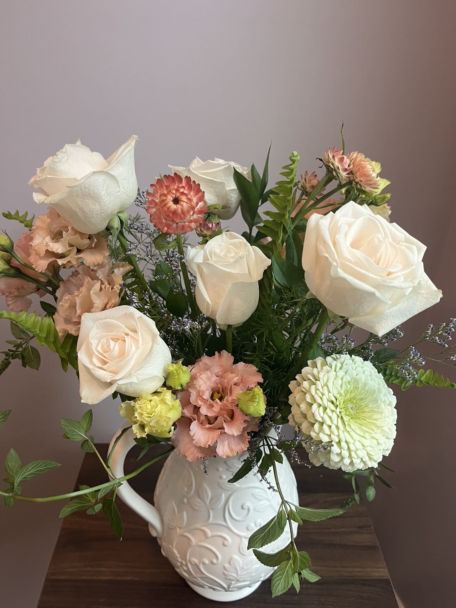 Soft Palette- Designer's Choice - This is a medium height arrangement filled with white and pastel colors.  The flowers used will vary depending on the season as we seek to add local flowers and greens as much as possible.  These arrangements will vary in the unique container they are created in from a bowl to a planter to a utensil holder.  This arrangement will be whimsical and soft.  Feel free to add the notes the purpose of the arrangement or something about the person.  Such as if the person is healing, I'll add lavender and aloe leaves as symbols of hope for healing. 