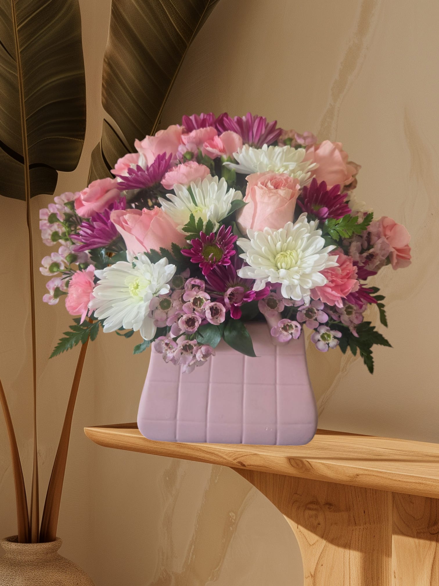 Pink and white mixed bouquet in a lavender vase