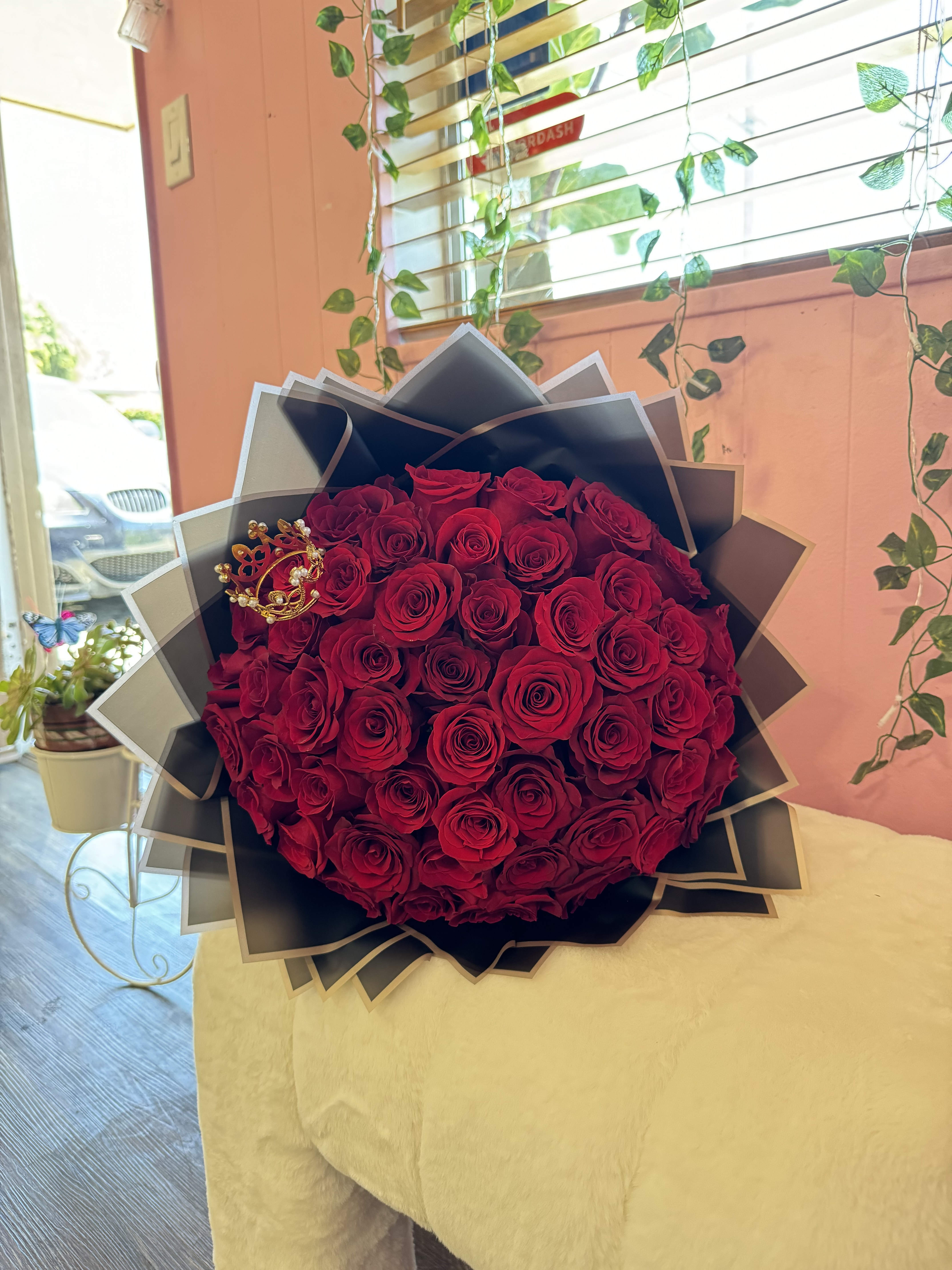 Large bouquet of red roses wrapped in black paper