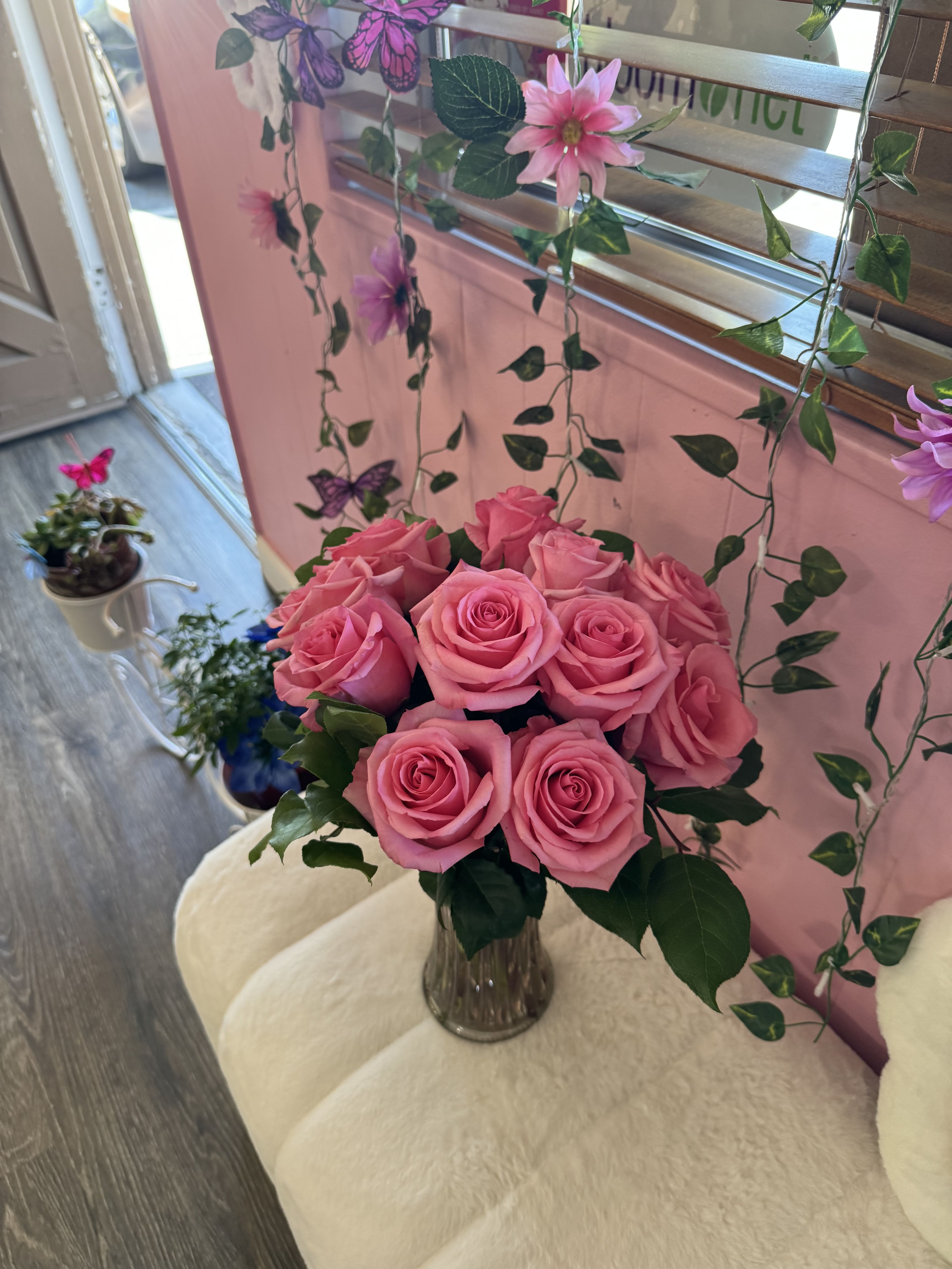 Pink roses arranged in a clear glass vase