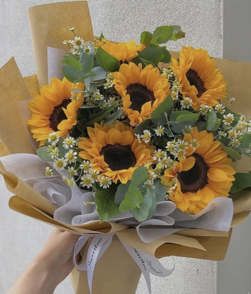 Bouquet of sunflowers with small white daisies and eucalyptus