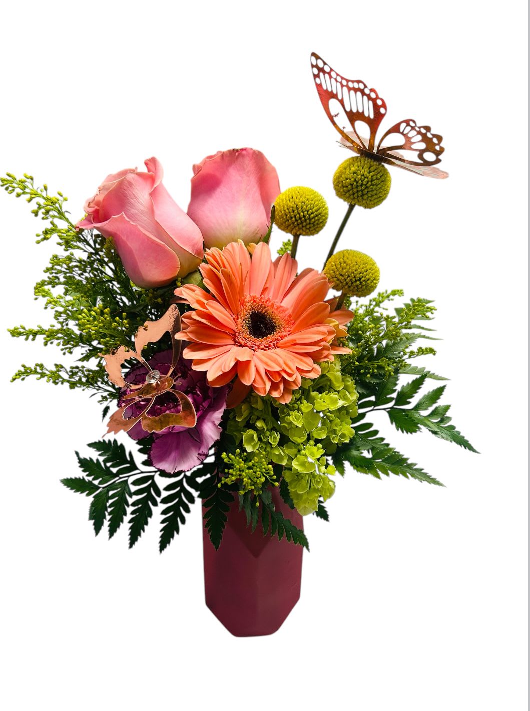 Pink roses and orange gerbera daisies in a burgundy vase with butterfly picks