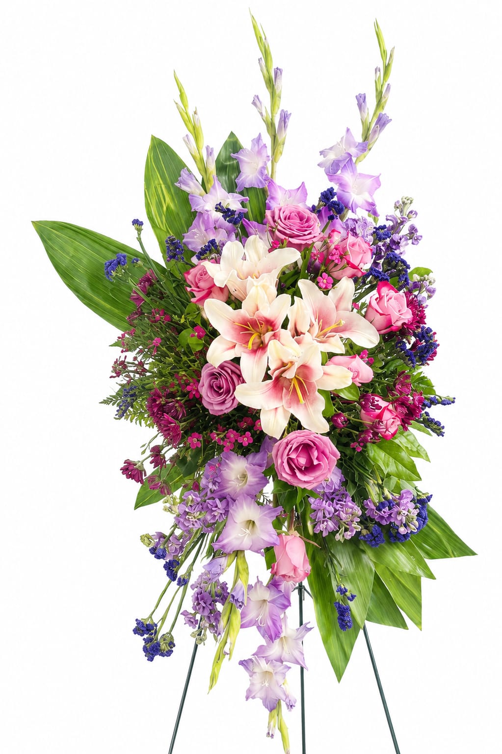 Graceful Tribute Standing Spray - Graceful Tribute Standing Spray  A beautiful expression of love, remembrance, and heartfelt sympathy, the Graceful Tribute Standing Spray combines soft pink lilies, lavender gladiolus, roses, and seasonal accent blooms in a palette of gentle pinks, purples, and creams. Designed on a standing easel, this elegant arrangement creates a striking display that offers comfort and honors a life well lived.  Featuring fragrant lilies, premium roses, graceful gladiolus, and lush greenery, this standing spray is appropriate for funeral services, memorial gatherings, church ceremonies, or celebration of life events. Its soothing colors and cascading design create a warm and dignified tribute that conveys love, respect, and lasting memories.  Approximate Size: 30" W x 54" H  Flowers may vary slightly based on seasonal availability while maintaining the overall style, color palette, and value of the arrangement.  Handcrafted with care by Spring Flower Market and delivered directly to local funeral homes, churches, and memorial venues throughout Spring, The Woodlands, Tomball, Magnolia, and surrounding communities.