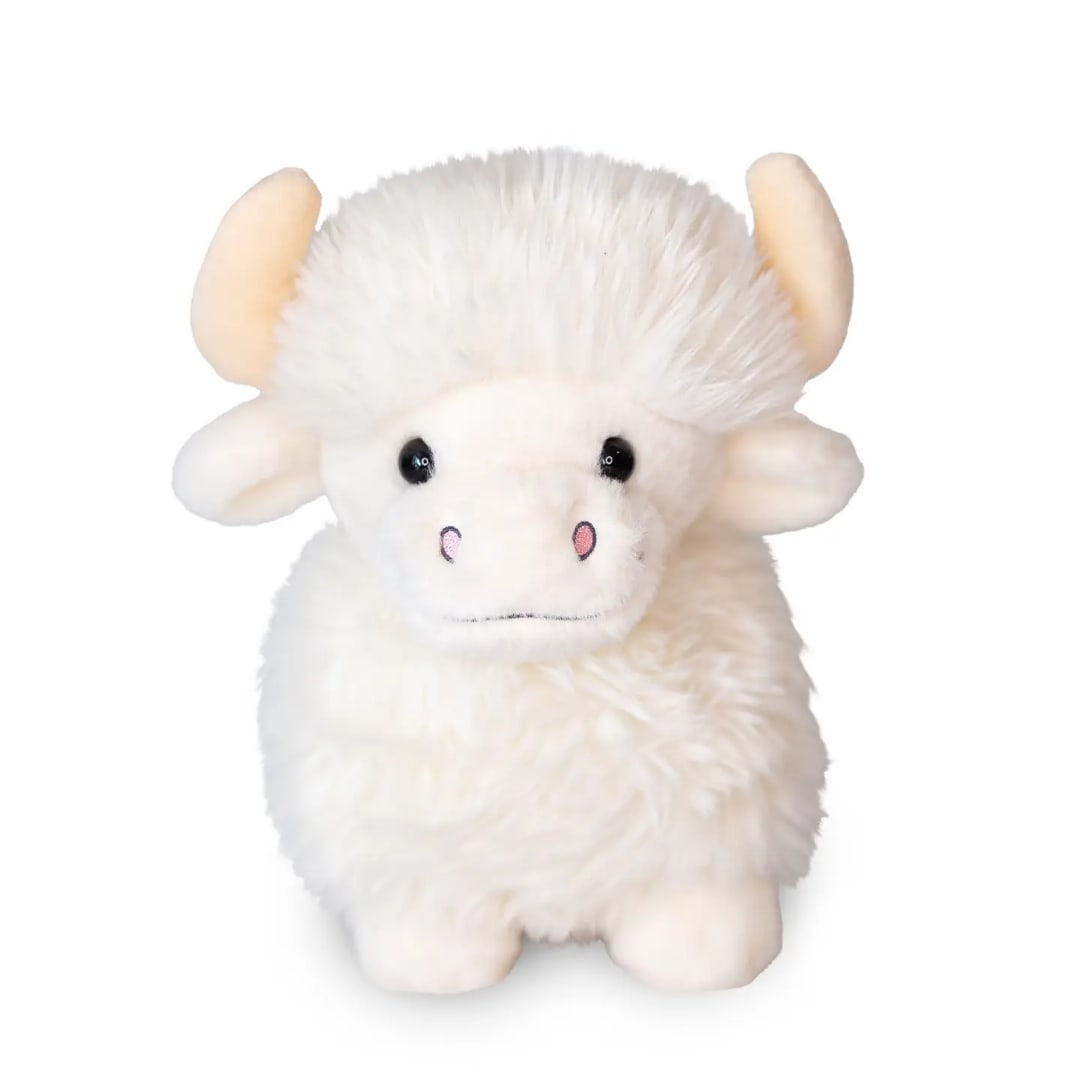 White plush cow toy with pink nose and small horns on a white background