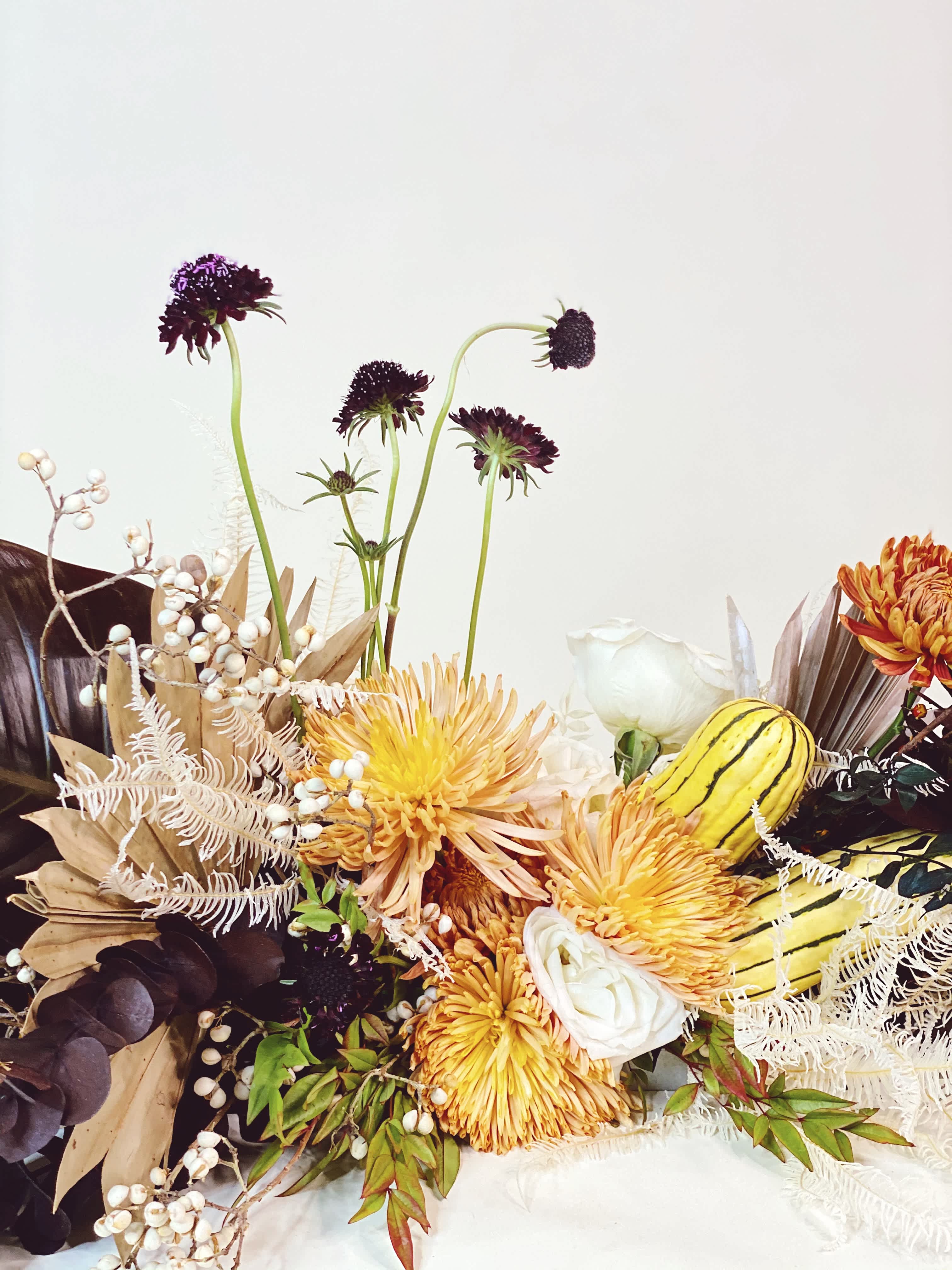 Autumn floral arrangement with yellow chrysanthemums and white roses