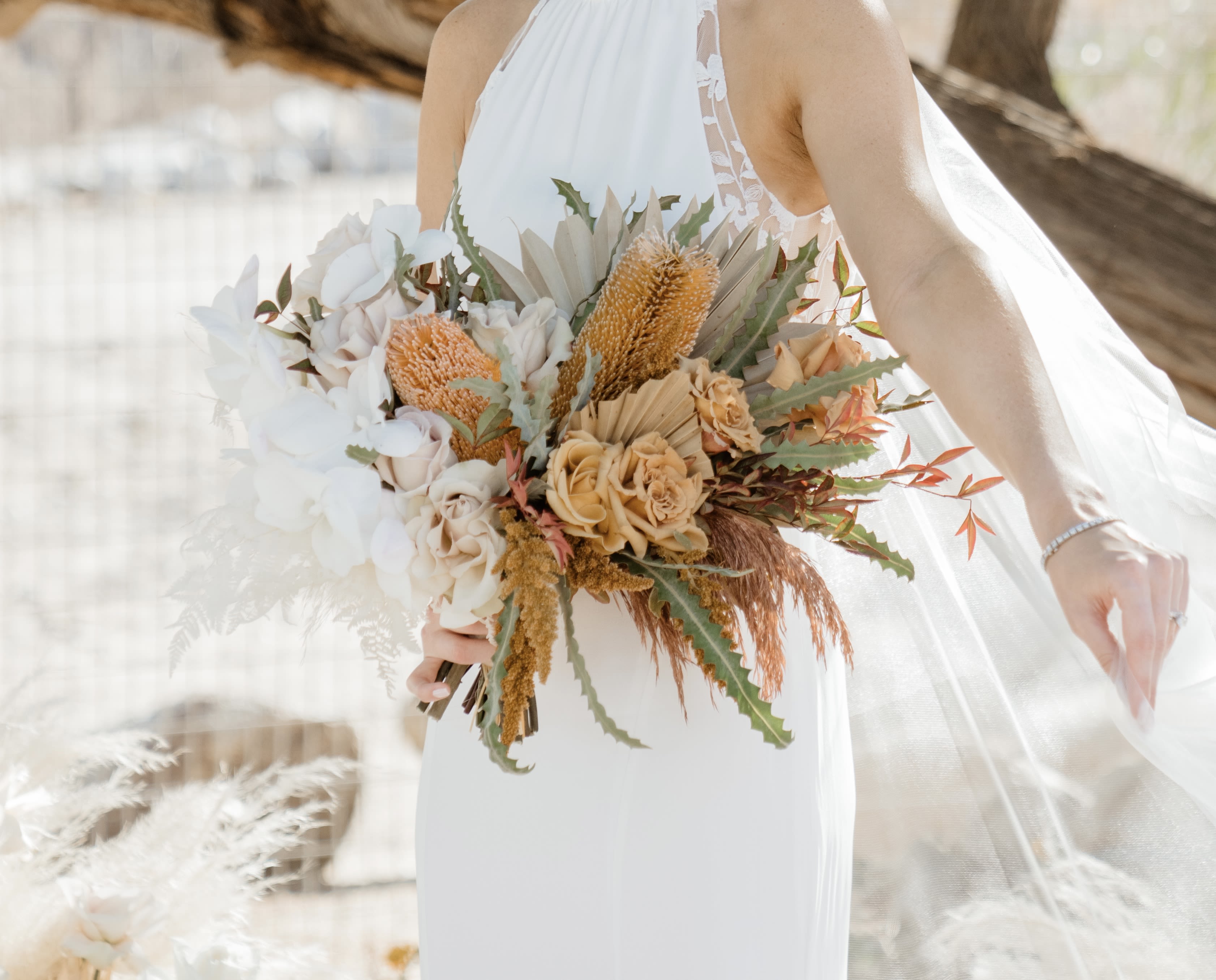 Bride holding a bouquet of white and peach flowers