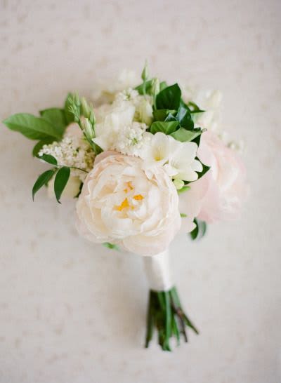 White and blush bouquet with greenery and a wrapped stem handle