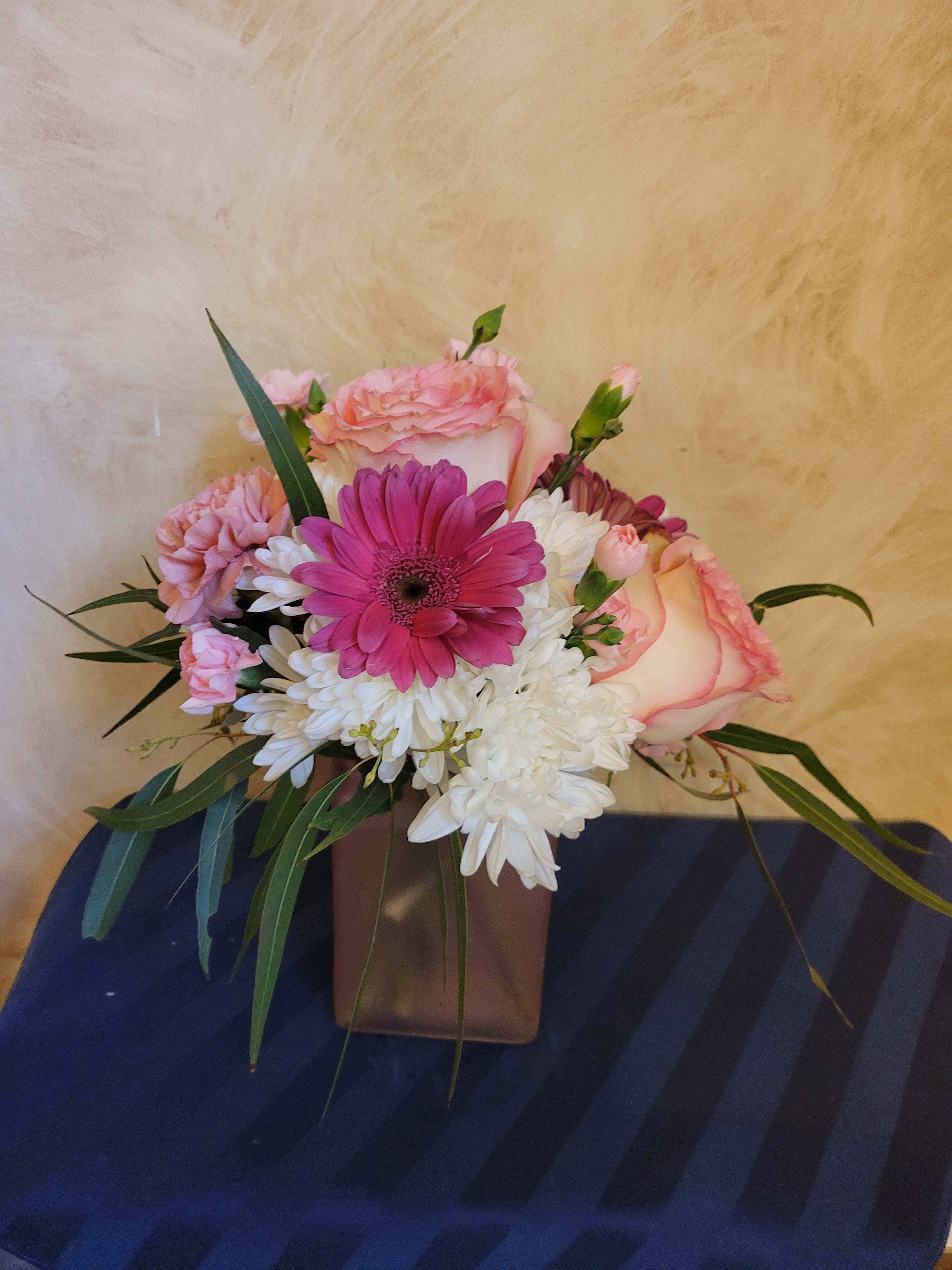Pink and white mixed bouquet in a brown vase