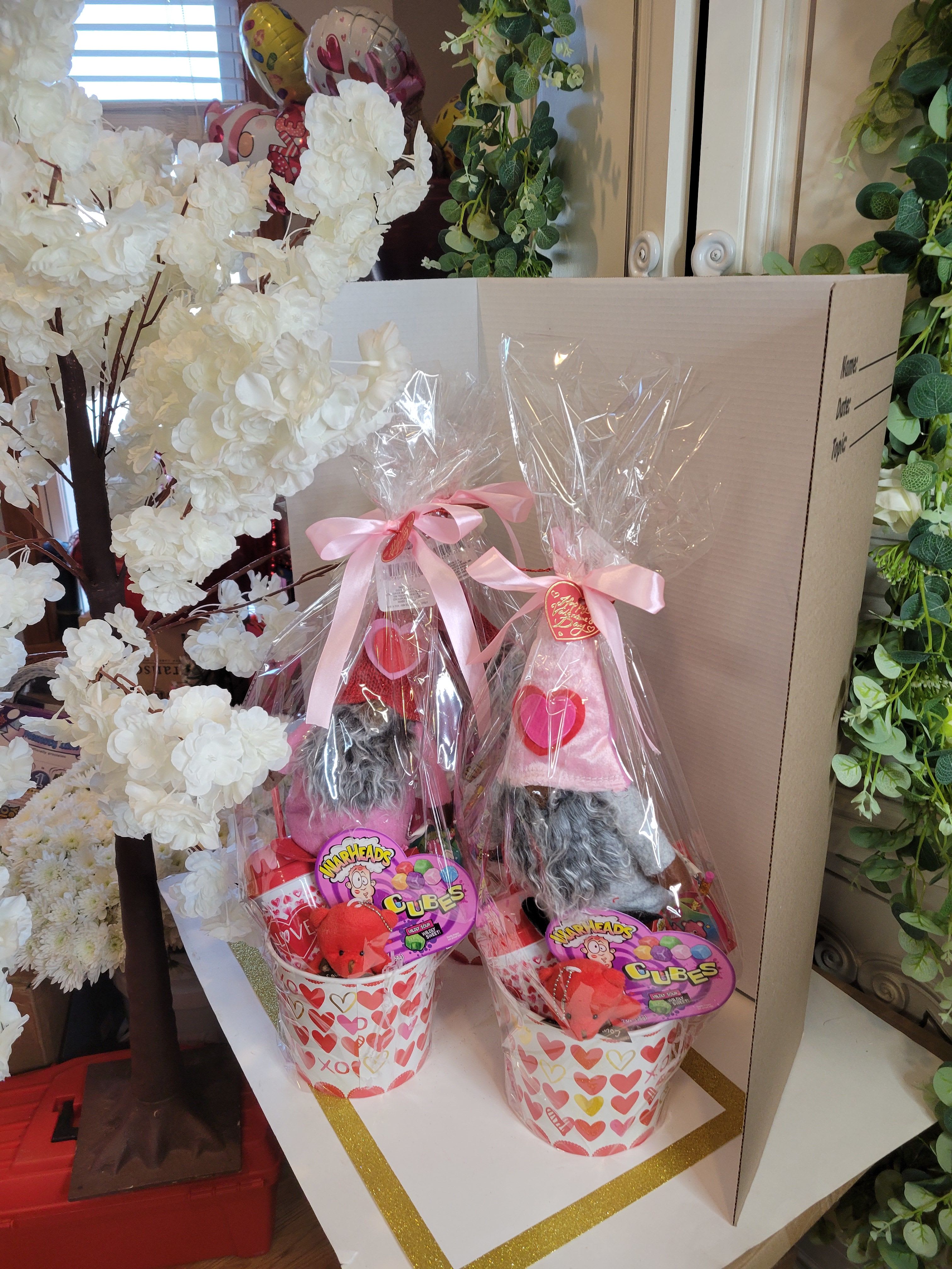 Two Valentine gift baskets with candy and plush gnomes