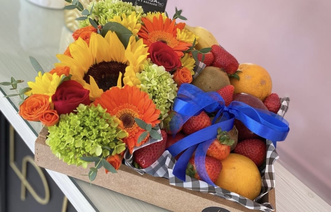 Bouquet with sunflowers, gerbera daisies, roses, and fruit in a box