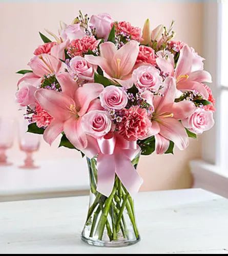 Expressions of Pink  - Expressing your feelings should always be this easy. Let our beautiful arrangement send the right message, with its stunning fresh pink blooms, including roses, lilies, carnations, and more, hand-arranged by our florists inside a classic vase. With sophistication and style, it will have them smiling no matter the occasion. Arrangement of pink roses, lilies, carnations, waxflower, and heather, accented with salal Artistically designed by our expert florists inside a clear glass vase with a stylish decorative ribbon; measures 11"H Large arrangement measures approximately 18"H x 11.5"L Medium arrangement measures approximately 17.5"H x 11"L Small arrangement measures approximately 17"H x 10.5"L Our florists hand-design each arrangement, so colors, varieties, and container may vary due to local availability Lilies may arrive in bud form and will open to full beauty over the next 2-3 days Although the actual bouquet may not precisely match the photo, its temperament will. Occasionally, substitutions of flowers and/or containers happen due to weather, seasonality and market conditions which may affect availability. If this is the case with the gift you’ve selected, we will ensure that the style, theme and color scheme of your arrangement is preserved and will only substitute items of equal value or higher value. If any design elements are of major importance to your order, please include them in the florist instructions at checkout or contact us to ensure availability.