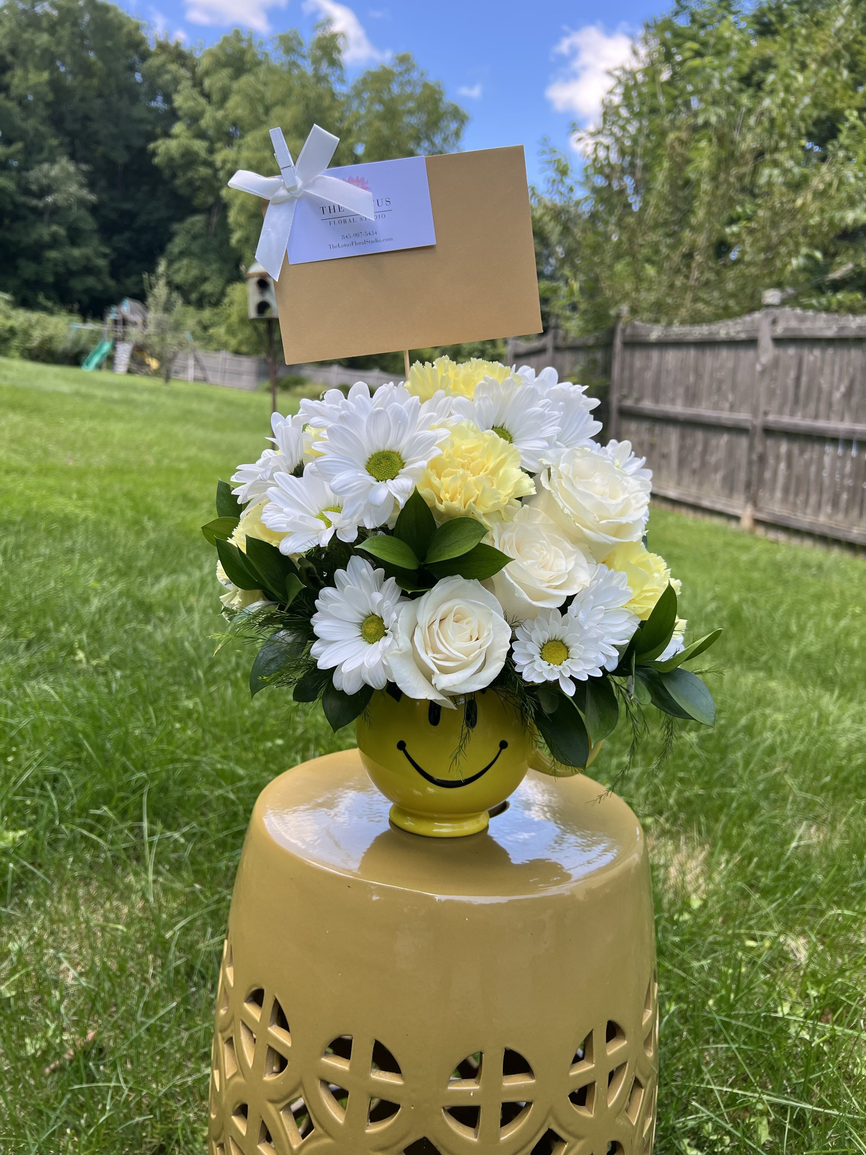 Smile Mug Arrangement - Put a smile on someones face with the Smile Mug Arrangement featuring white or yellow daisies ,white or yellow roses, and white or yellow carnations!