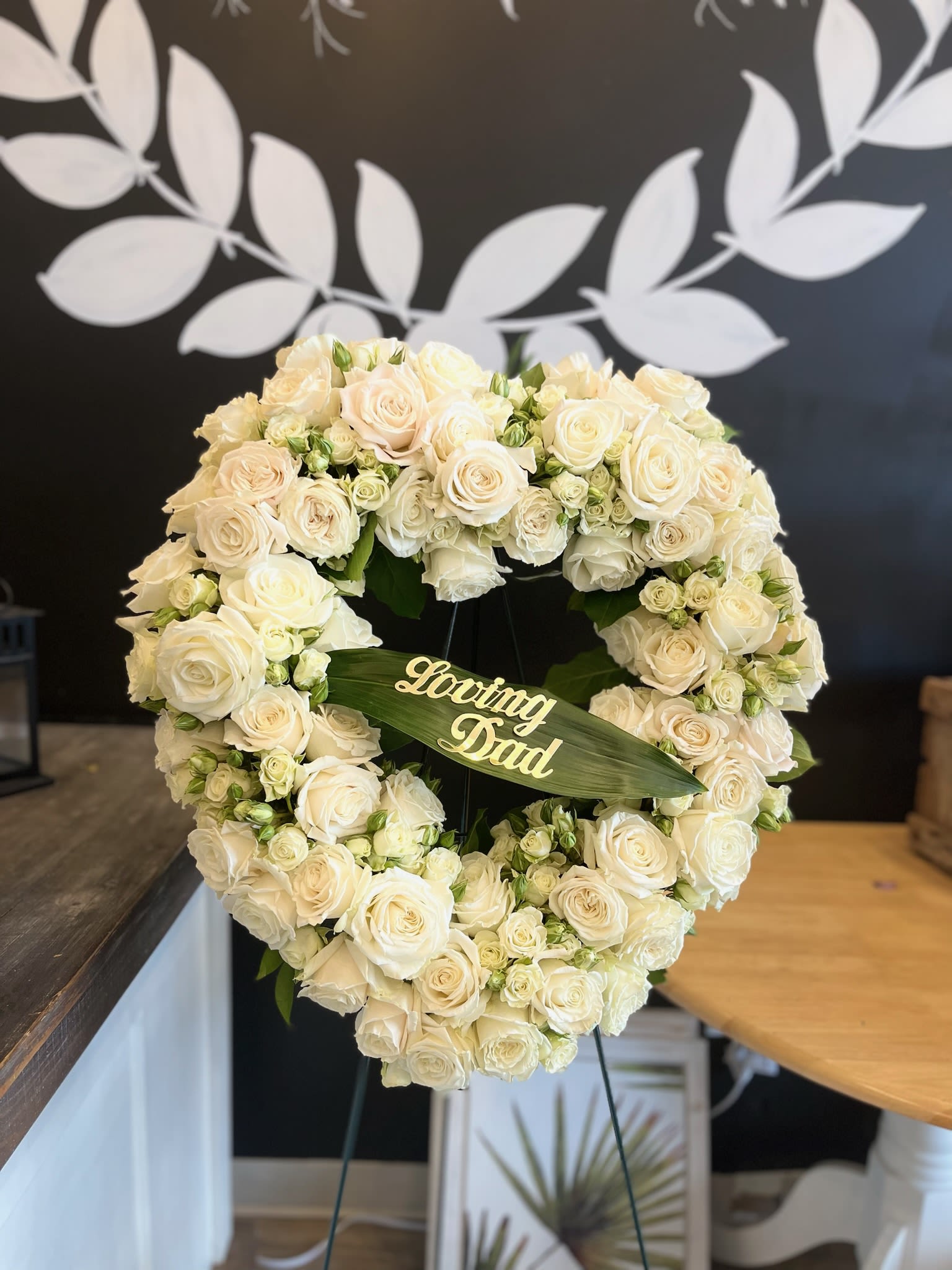 Heart-shaped white rose wreath with a "Loving Dad" plaque