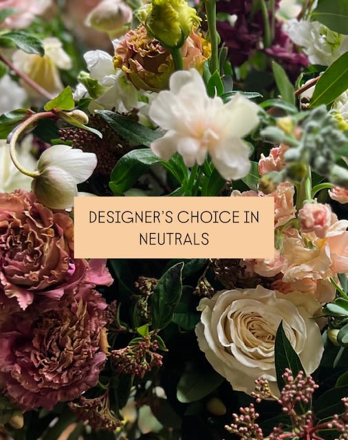 Mixed bouquet of neutral-toned flowers with a label reading designer's choice in neutrals