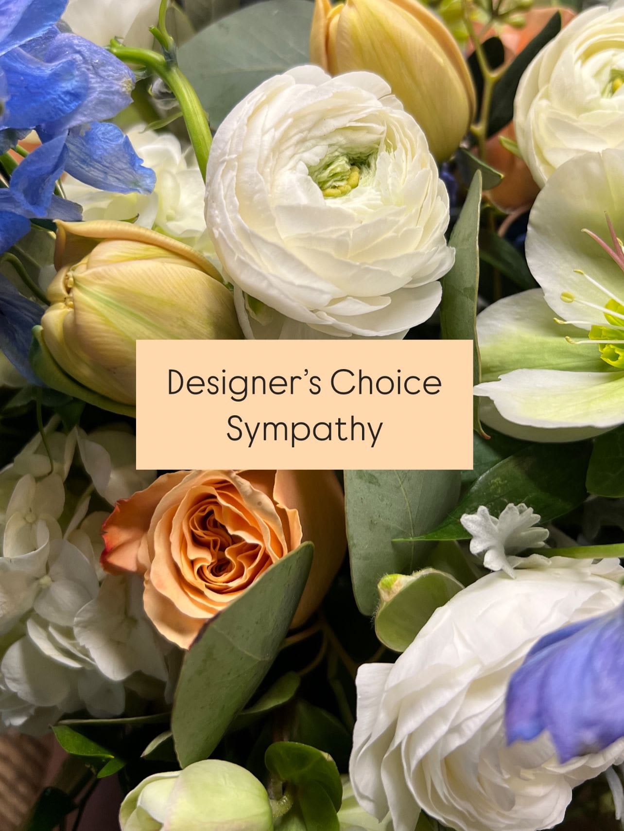 Mixed sympathy bouquet with white and peach blooms and blue flowers
