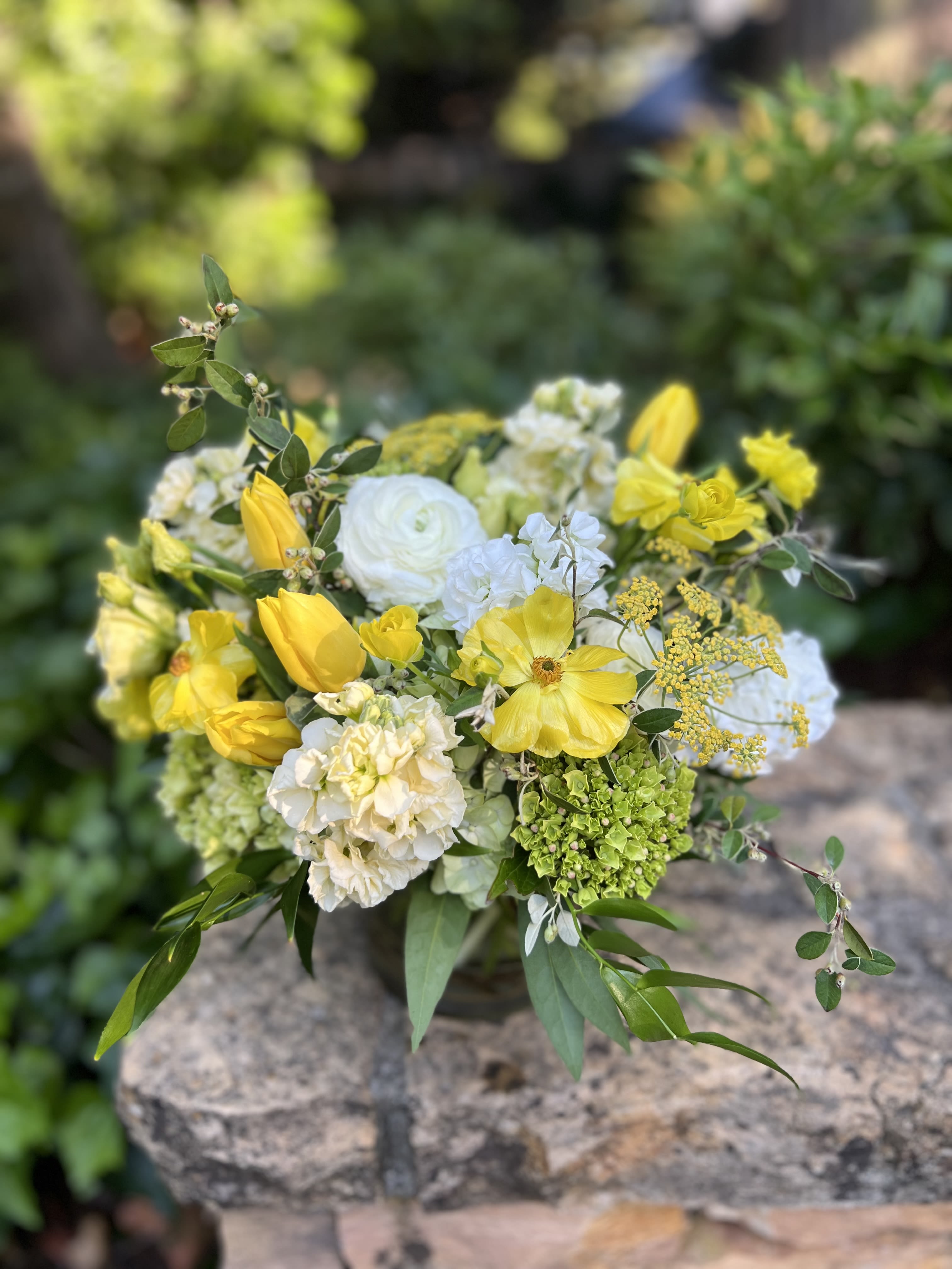 Yellow and white bouquet with tulips, ranunculus, and hydrangea