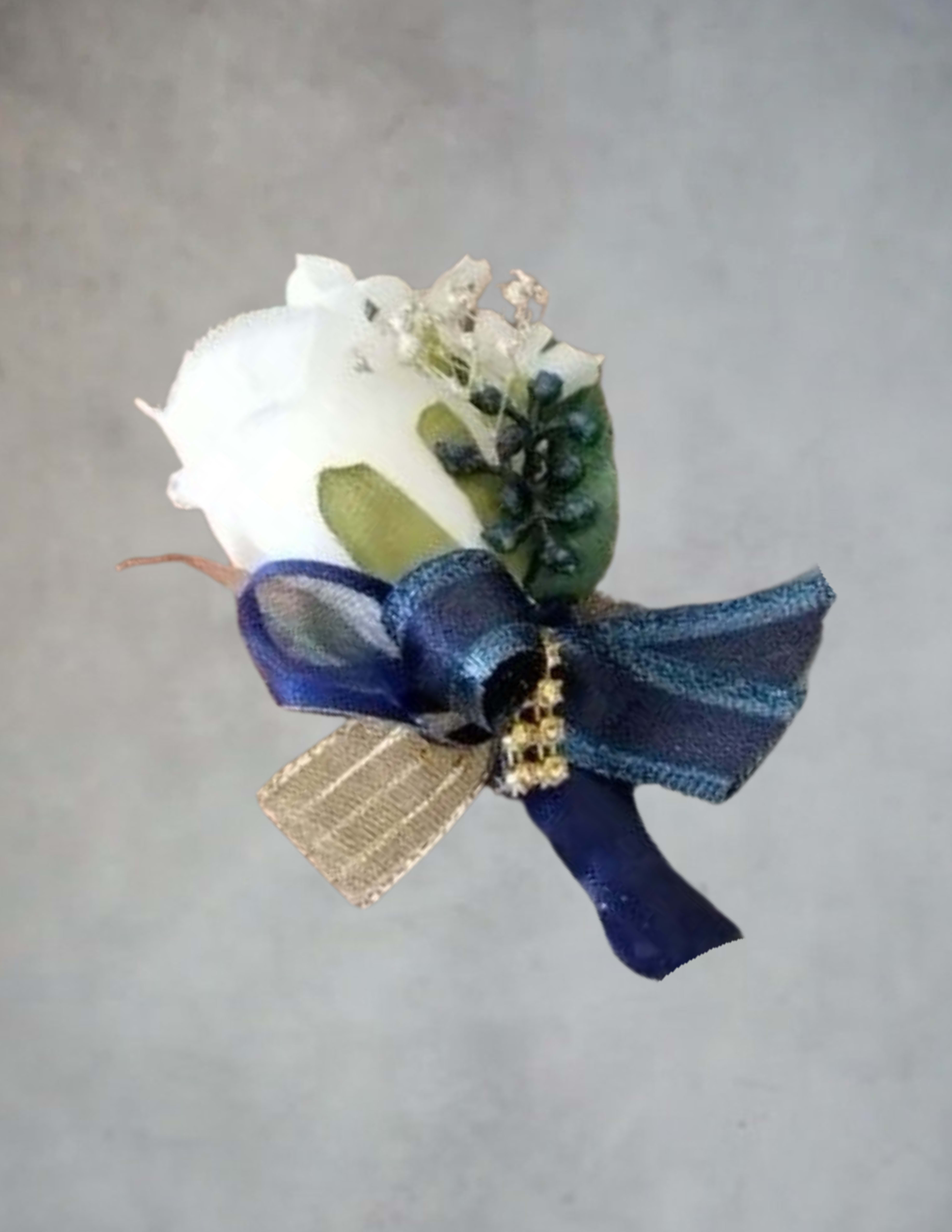 White rose boutonniere with blue ribbon and gold accent