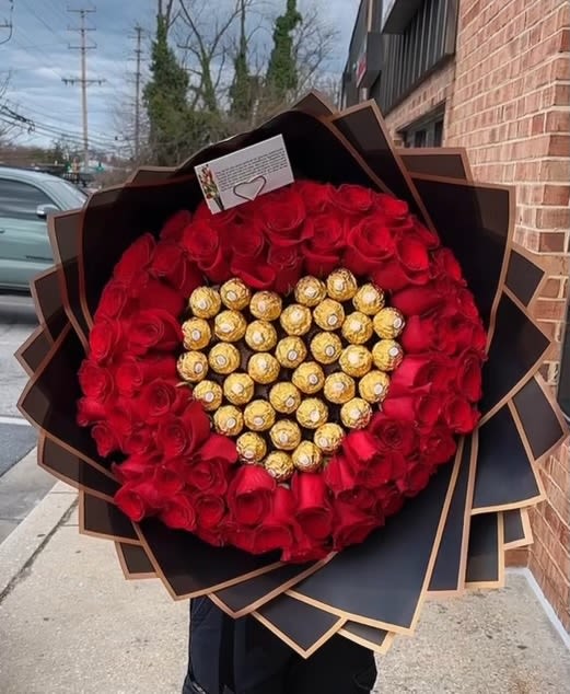 Heartfelt Indulgence Bouquet - The Heartfelt Indulgence bouquet is the epitome of luxury and romance. This stunning arrangement features a lavish display of rich red roses, artfully arranged to encircle a heart made of indulgent Ferrero Rocher chocolates. Wrapped in sophisticated black and gold paper, this bouquet is more than just flowers—it's an experience. Perfect for someone special, this exquisite gift combines the timeless beauty of roses with the sweet delight of chocolates, making it an unforgettable gesture of love and appreciation.