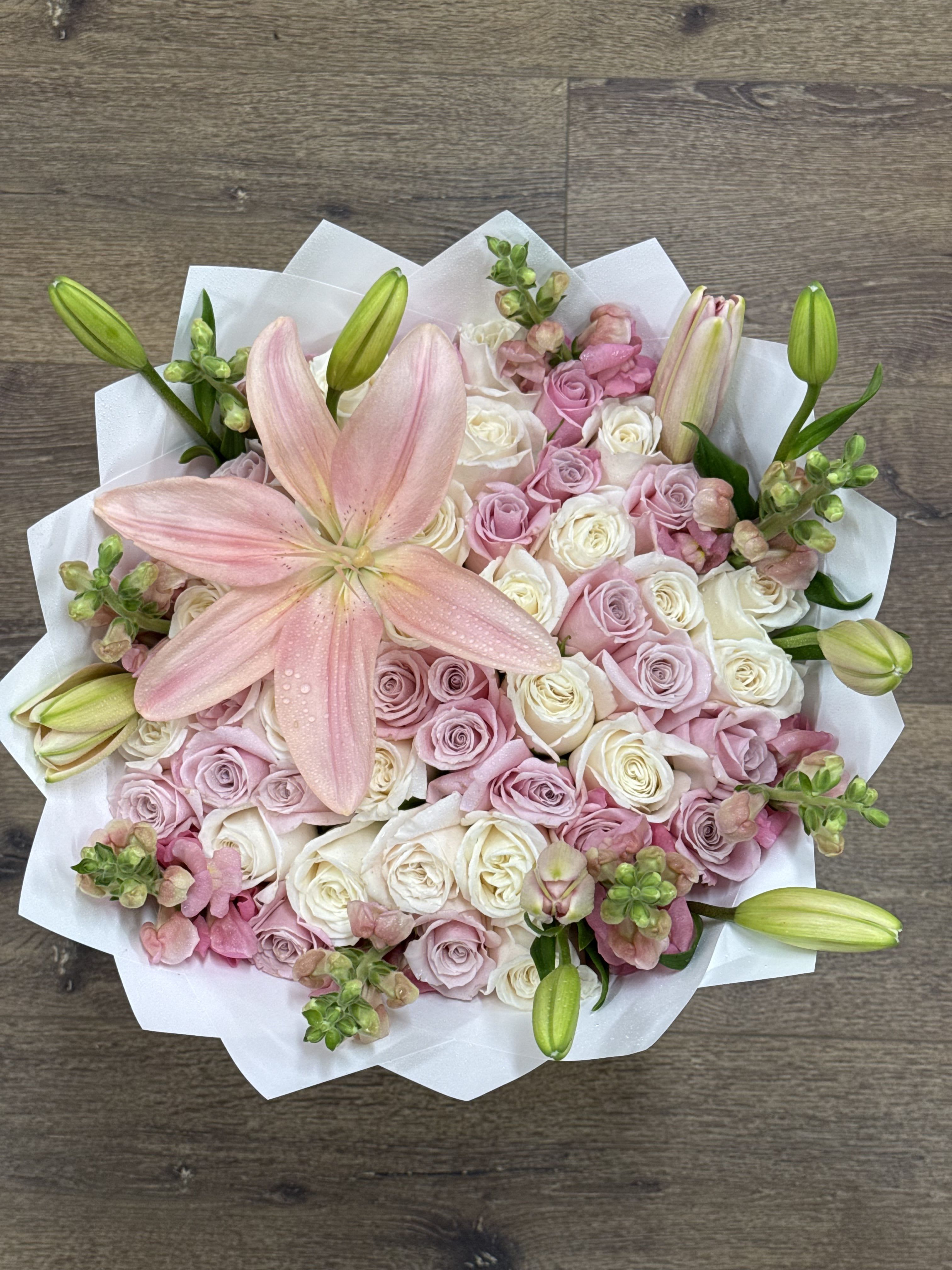 Blush Serenade Bouquet - The Blush Serenade is an elegant hand-tied bouquet designed to create a moment of pure romance. This lush arrangement features a gorgeous mix of pink and white blooms, making it an unforgettable gift in the Beltsville, MD, area. We've combined fragrant Pink Lilies with dozens of premium White and Lavender Roses, accented by towering, sweet-smelling Stock flowers. This stunning presentation is the ultimate way to express deep affection. It is the perfect arrangement for:  Celebrating an Anniversary or milestone A meaningful Valentine's Day or Mother's Day surprise Sending a thoughtful Congratulations gift  Order this beautiful, rose-filled bouquet today from Vivi's Flower Market, your local Beltsville florist, and send your most heartfelt sentiments.