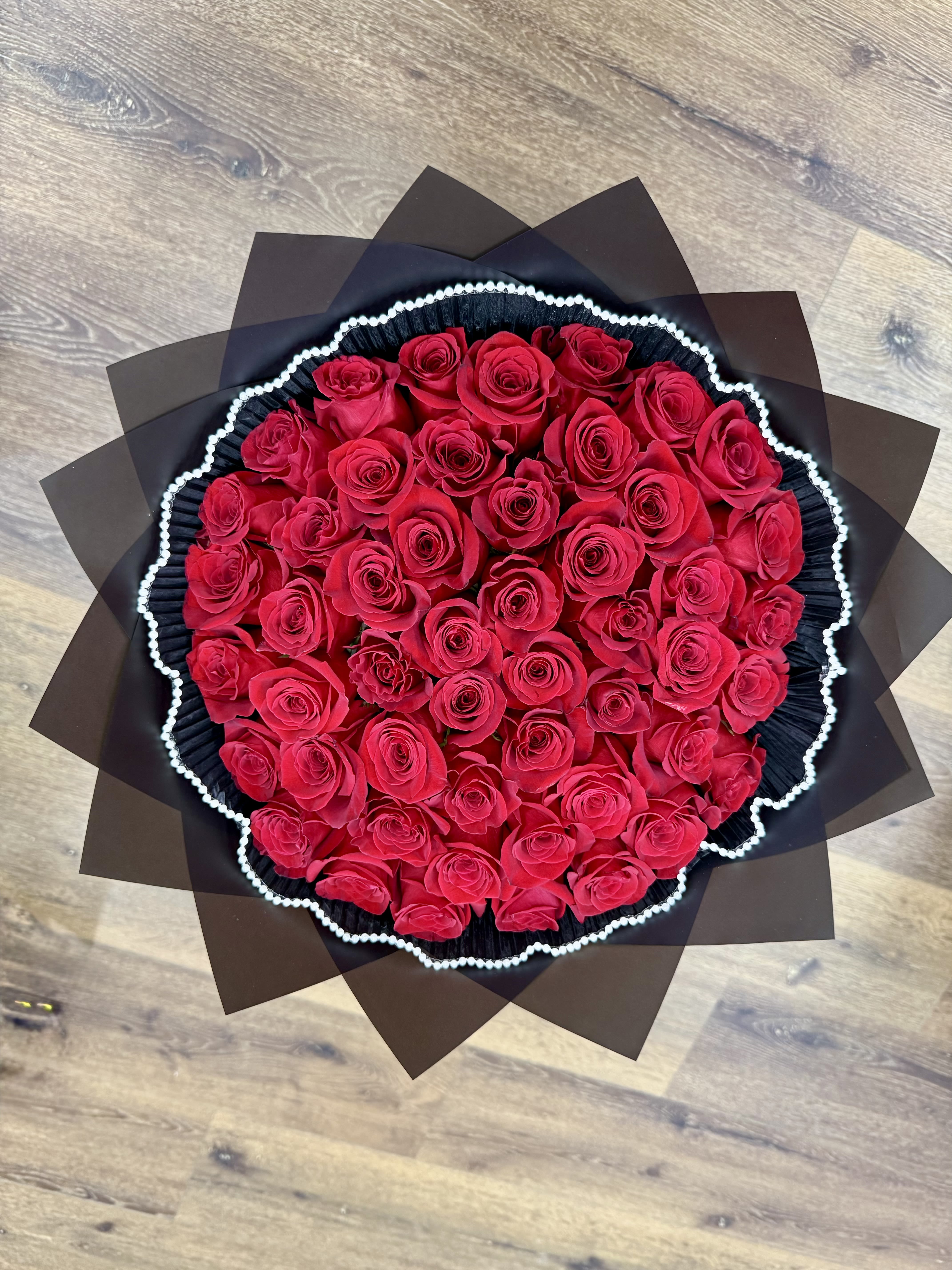 Forever Yours Bouquet - This beautiful bouquet holds long stem red roses wrapped in black waterproof Korean paper wrap and black mesh with a white liner. *Pictured product has 50 roses*