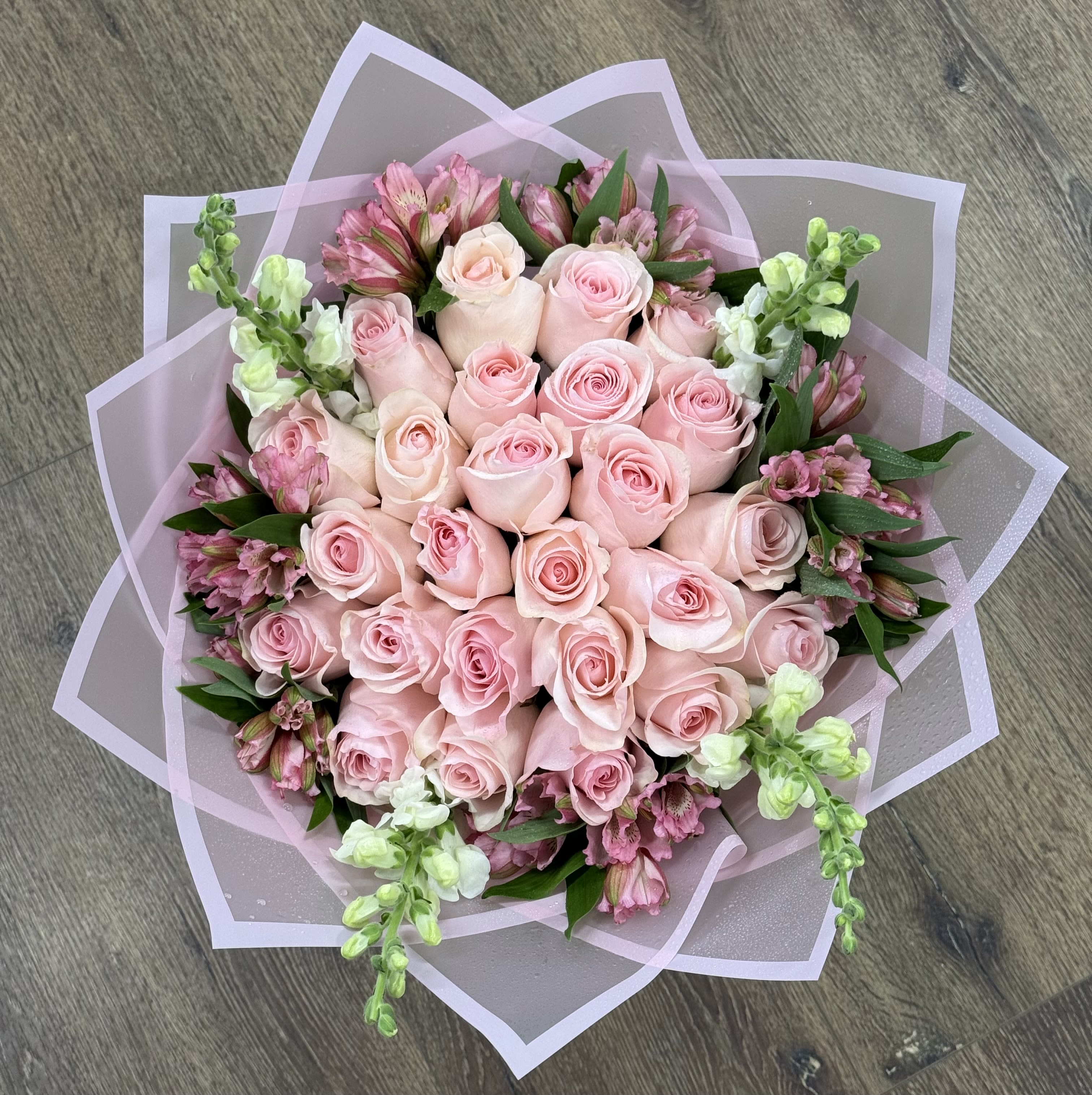 Bouquet of pale pink roses with pink and white accent flowers