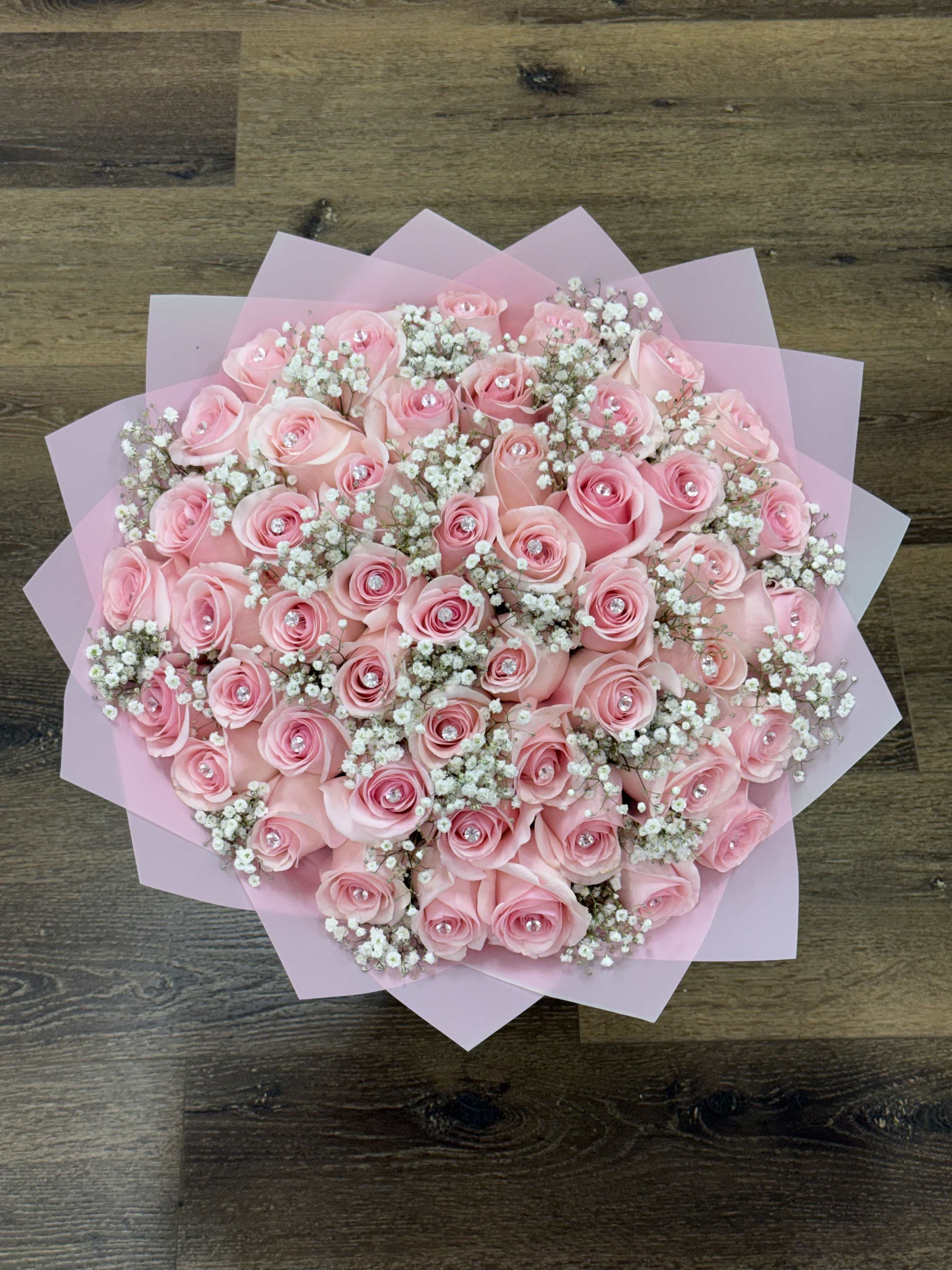 Pink rose bouquet with baby's breath wrapped in pink paper