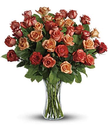 Sunrise Splendor - The sun will come out tomorrow, and tomorrow, and tomorrow with this blazing bouquet of orange roses. Orange, light orange and dark orange - gorgeous roses delivered in a sparkling flared glass vase. No doubt about it, this is one hot gift. This spectacular bouquet includes orange roses, light orange roses and dark oranges accented with salal. Delivered in a flared glass vase. Orientation: All-Around