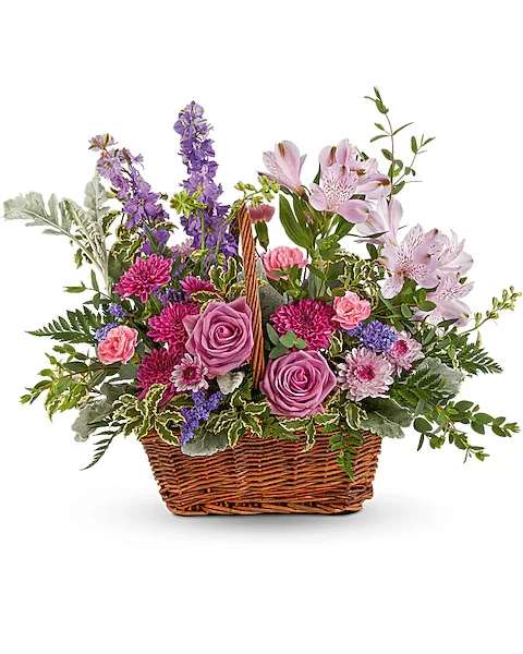 Mixed flower basket with pink and purple blooms in a wicker basket