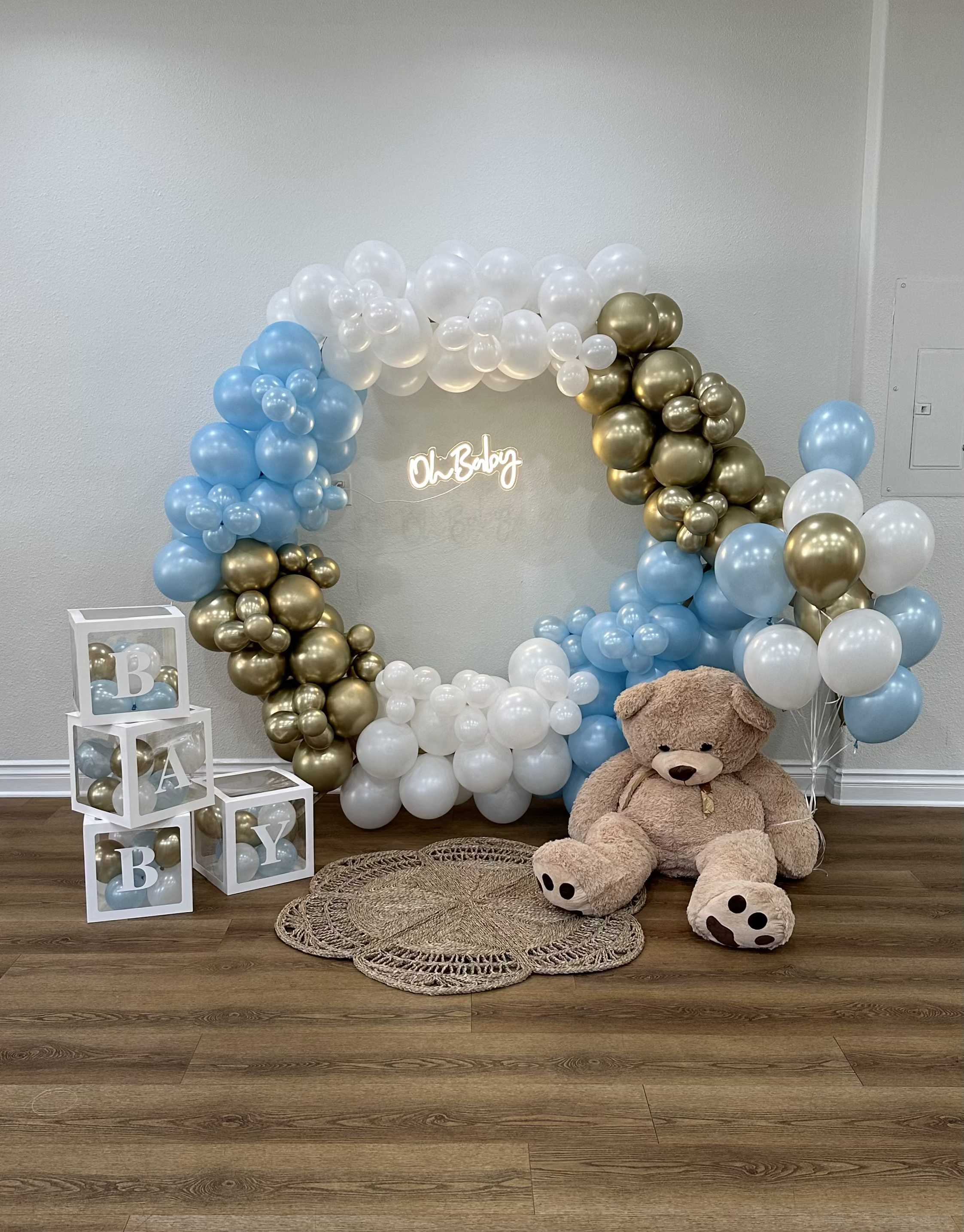 Baby shower balloon arch with teddy bear and letter blocks