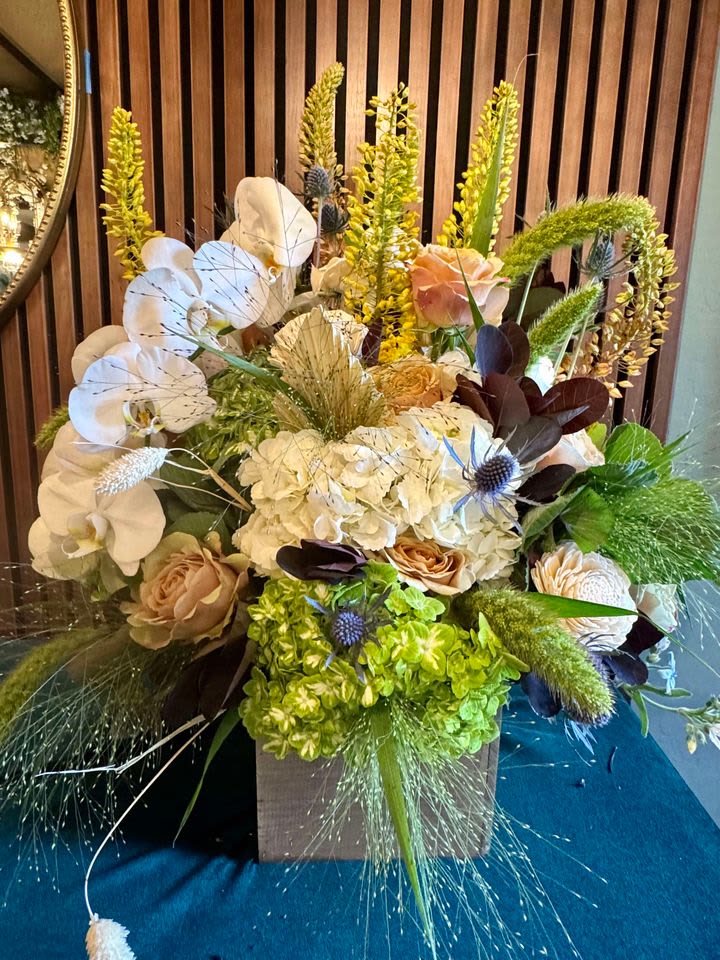 Exotic Elegance Bouquet - Experience a touch of opulence with the Exotic Elegance Bouquet! This stunning arrangement showcases an array of premium blooms, including lush roses, vibrant hydrangeas, and enchanting Tweedia, complemented by the graceful texture of pampas grasses and a hint of luxurious tropical elements. Arranged in a sophisticated vase, this bouquet offers a captivating blend of colors and textures, making it the perfect choice for adding a touch of elegance and charm to any occasion.  Substitution Policy – Always Fresh, Always Beautiful!  We strive to deliver the freshest flowers and the most exquisite arrangements. Please note that the bouquet image reflects our original design. In the event that specific flowers or containers are unavailable, our skilled local florists will use the freshest available blooms to create a stunning and comparable bouquet that maintains the spirit and beauty of the original design. Your satisfaction is our priority, and we are committed to delivering a beautiful floral experience every time! 