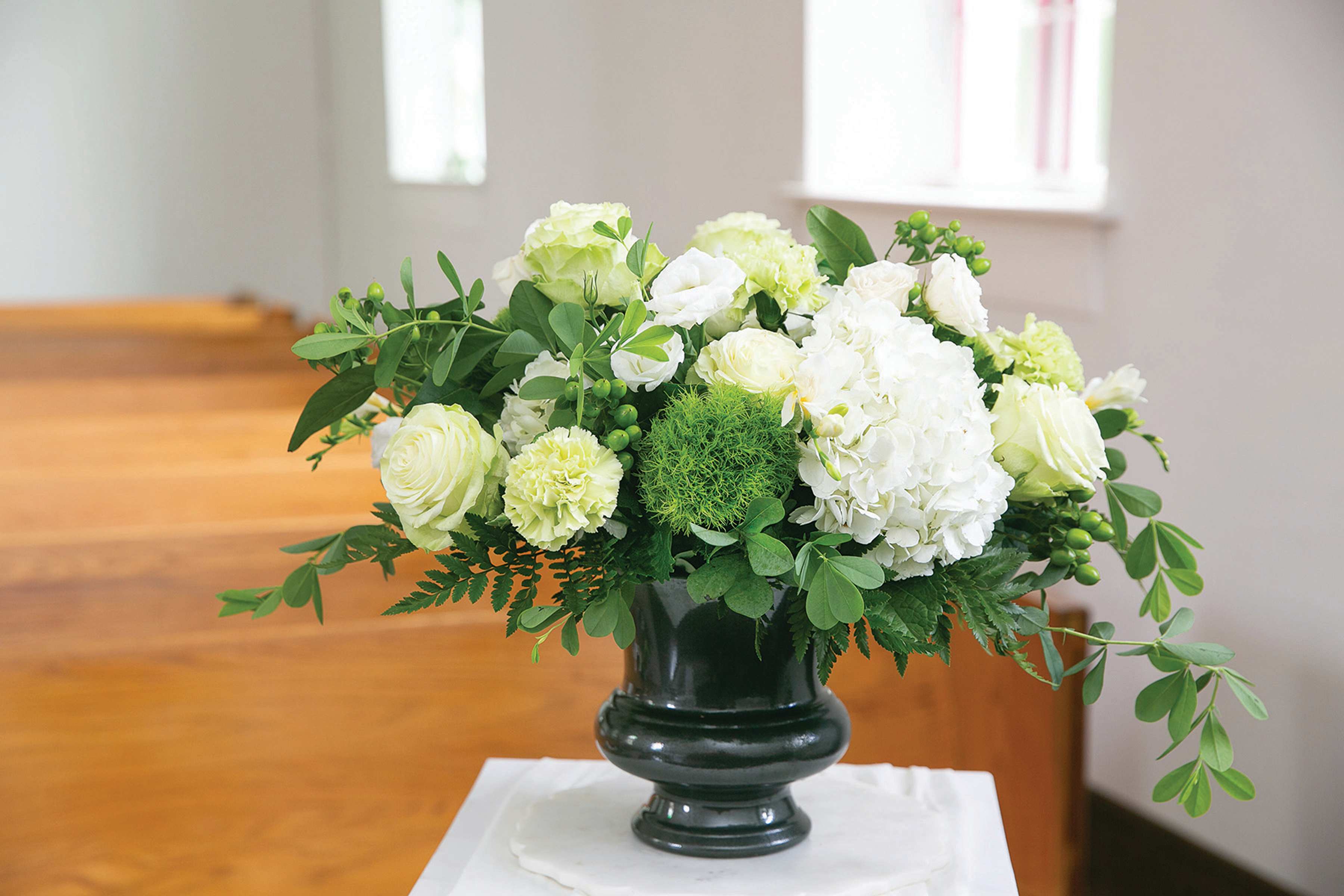 White floral arrangement in a dark vase