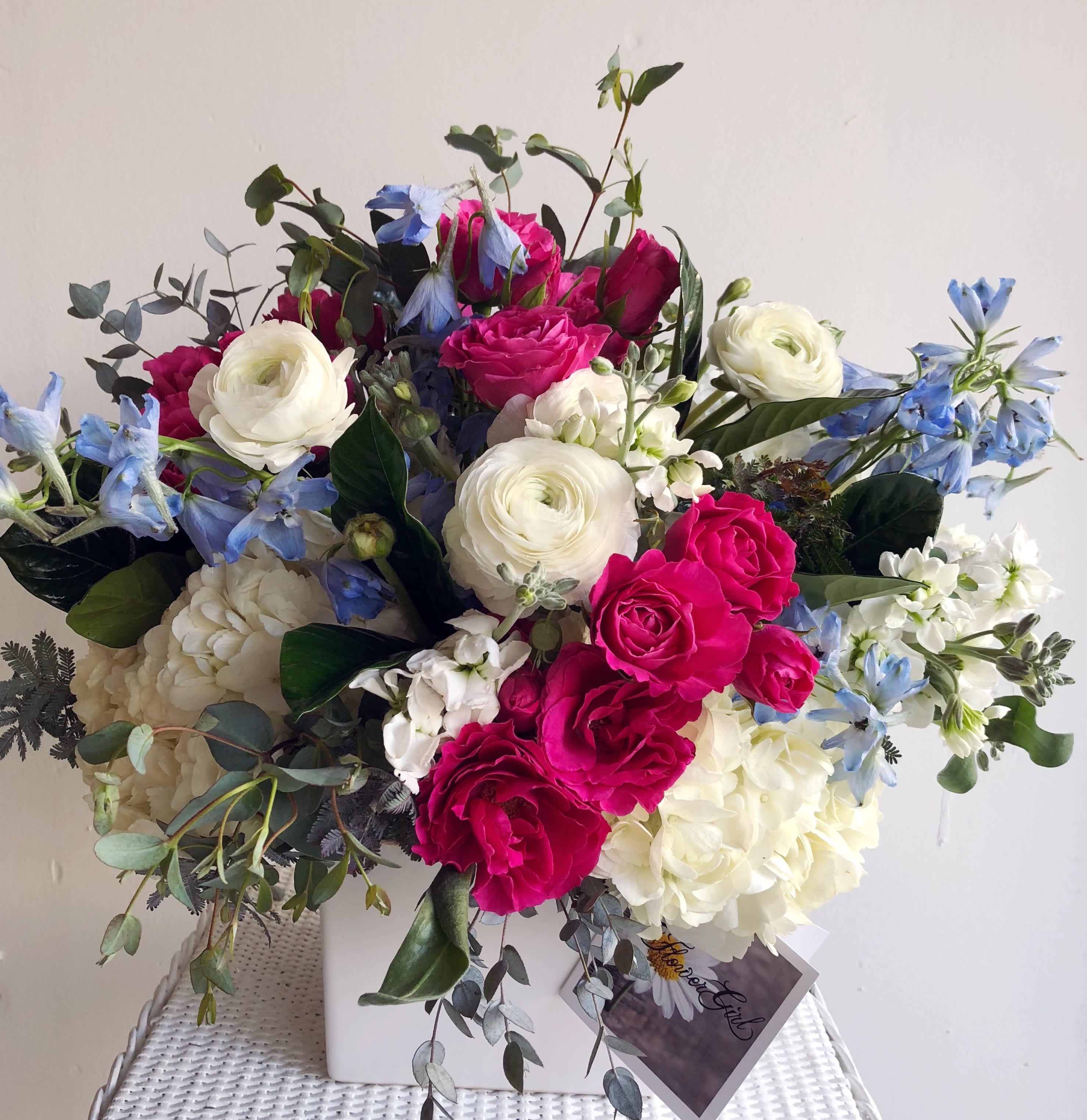 FOURTH DAY OF JULY - Elegant, sophisticated, and full of charm — The Fourth Day of July piece is a stunning arrangement featuring a harmonious blend of large red, white, and blue hydrangea, roses, ranunculus, all artfully arranged in a crisp 5x5 white container. This bouquet captures the essence of refined beauty, making it a perfect gift for someone special.​  Ideal for anniversaries, birthdays, or simply to brighten someone's day. A favorite among customers all over San Diego, searching for fourth of July flowers, elegant floral arrangements, sophisticated bouquets, or same-day flower delivery.​  