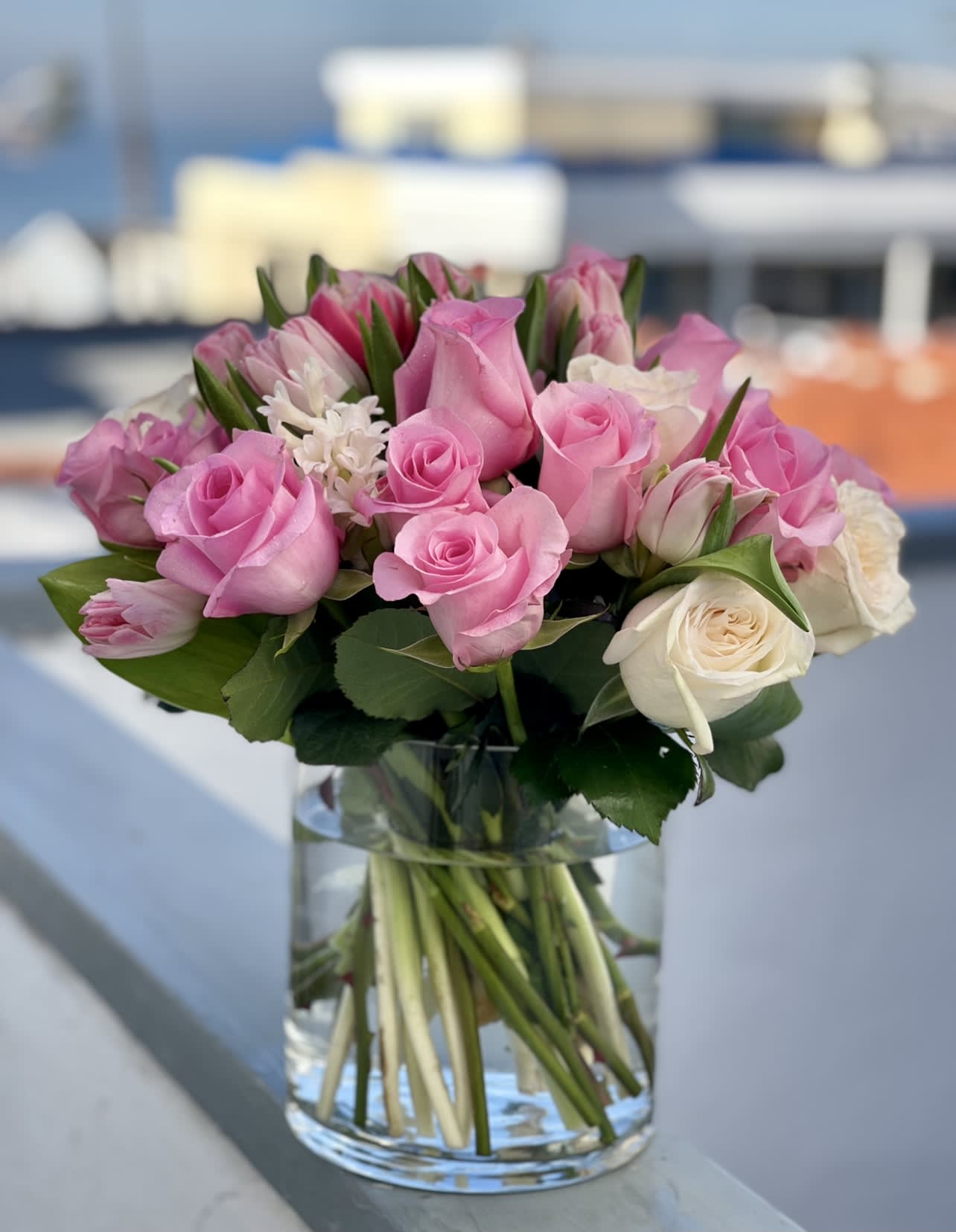 PINK &amp; PERFECT - Elegant, romantic, and full of charm — Pink &amp; Perfect is a stunning arrangement featuring a harmonious blend of at least 12 perfect pink roses, gorgeous white roses, hyacinth, and double-stem tulips, all artfully arranged in a 6x5 heavy glass container. This bouquet captures the essence of love and beauty, making it a perfect gift for someone special.​  Ideal for anniversaries, birthdays, or simply to brighten someone's day. A favorite among customers in San Diego searching for pink floral arrangements, elegant bouquets, or same-day flower delivery.​  