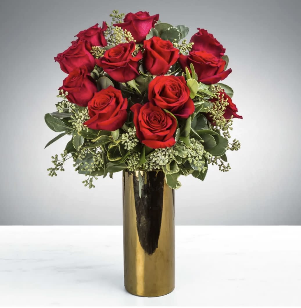 HEAD OVER HEELS - One dozen of the finest red roses you can buy, nestled in a beautiful gold container, all dressed up with fancy, pretty, fragrant greenery.