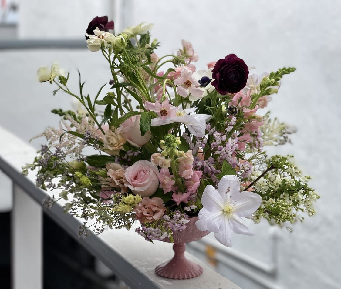 OVER THE MOON - Elegant, romantic, and full of celestial charm — Over the Moon is a stunning arrangement featuring a harmonious blend of roses, anthurium, ranunculus, dendrobium orchids, lisianthus, hydrangea, tea leaves, and bells of Ireland, all artfully arranged in our signature "Moon" vase. This bouquet captures the essence of love and beauty, making it a perfect gift for someone special.​  Ideal for anniversaries, romantic gestures, or simply to express your deepest emotions. A favorite among customers in San Diego and North County searching for romantic floral arrangements, luxurious bouquets, or same-day flower delivery.​  