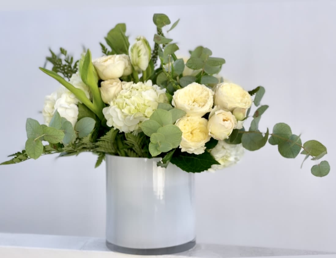 IVORY ELEGANCE - Elegant, timeless, and full of grace — Ivory Elegance is a stunning arrangement featuring a harmonious blend of white and cream blooms, artfully arranged to convey sophistication and serenity. This bouquet captures the essence of refined beauty, making it a perfect gift for someone special.​  Ideal for weddings, anniversaries, or simply to brighten someone's day. A favorite among customers in San Diego, Oceanside, and Carlsbad searching for white floral arrangements, elegant bouquets, or same-day flower delivery.