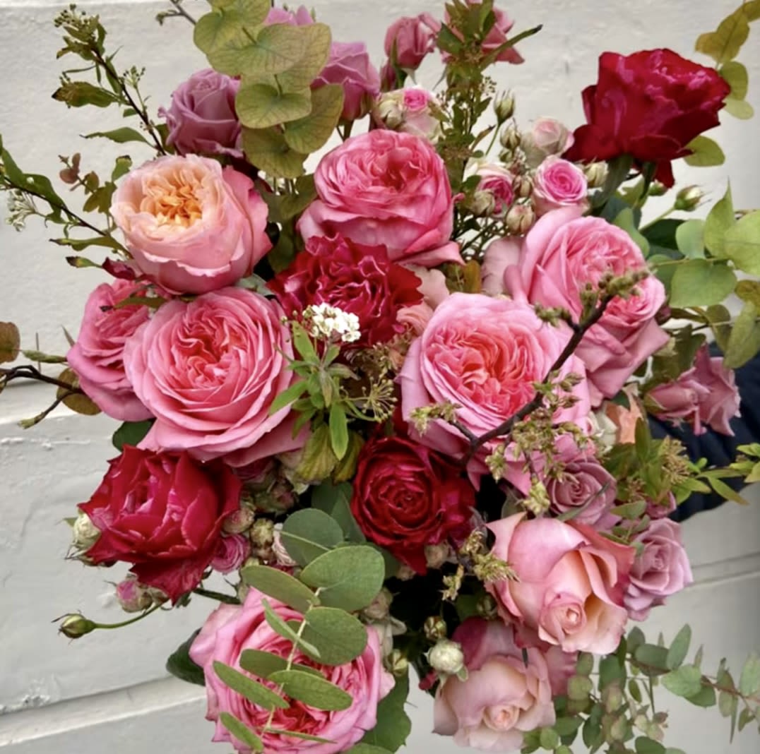 Bouquet of pink and red roses with eucalyptus