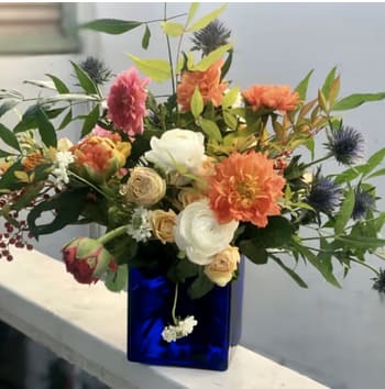 JOYRIDE - Bright, whimsical, and full of life — Joyride is a stunning arrangement featuring a harmonious blend of vibrant blooms, including poppies, artfully arranged in a charming blue glass container. This bouquet captures the essence of joy and creativity, making it a perfect gift for someone special.​  Ideal for birthdays, celebrations, or simply to brighten someone's day. A favorite among customers in San Diego, for vibrant floral arrangements, whimsical bouquets, poppy flower arrangements, or same-day flower delivery.