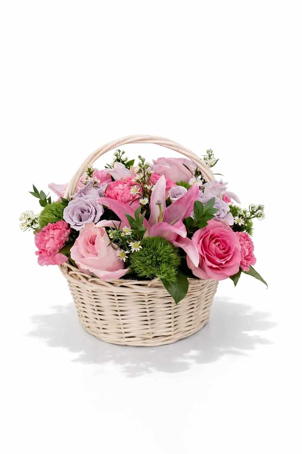 Pink and lavender flowers arranged in a wicker basket